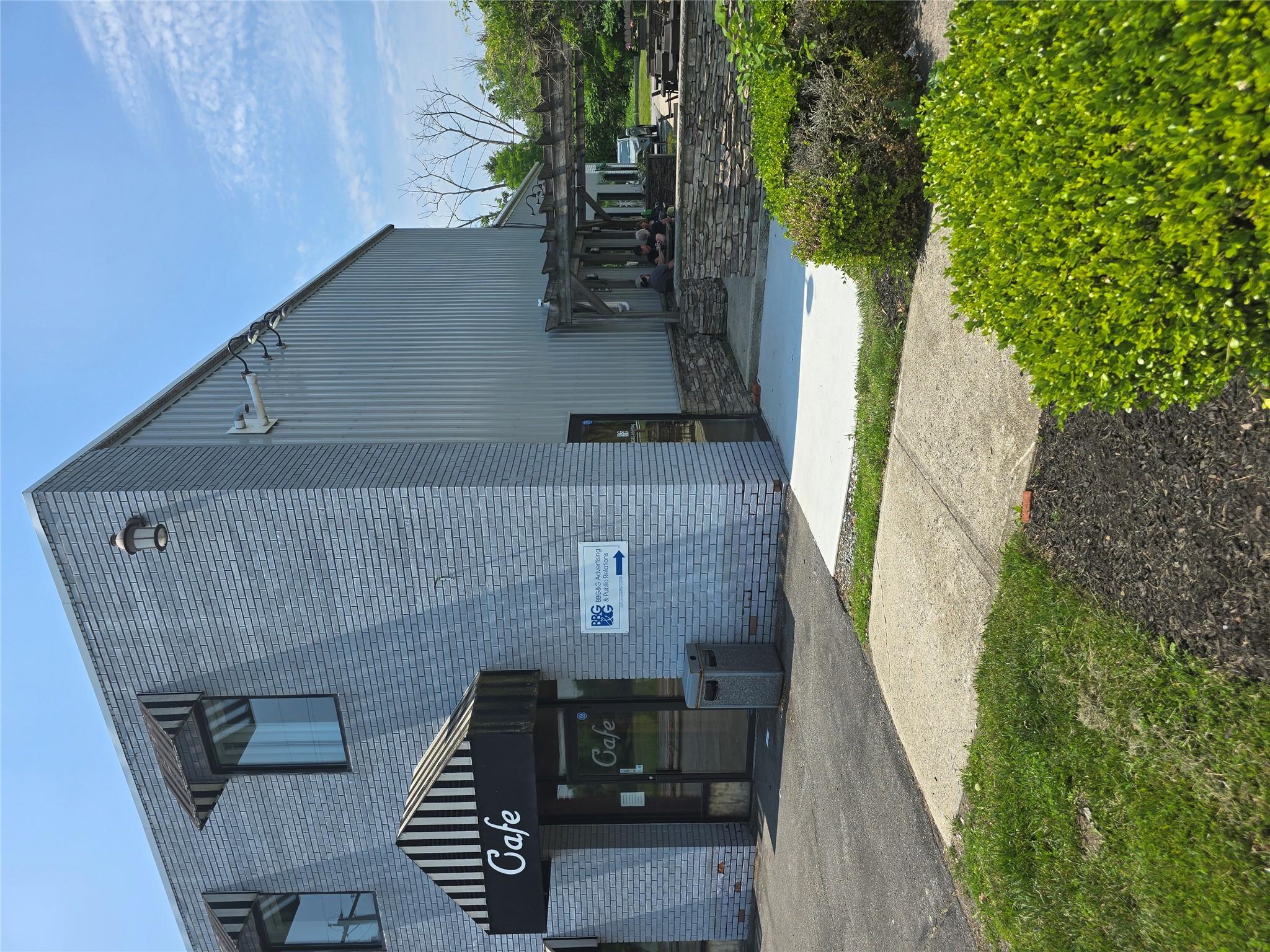 View of building exterior. Entrance to the right side of the cafe.