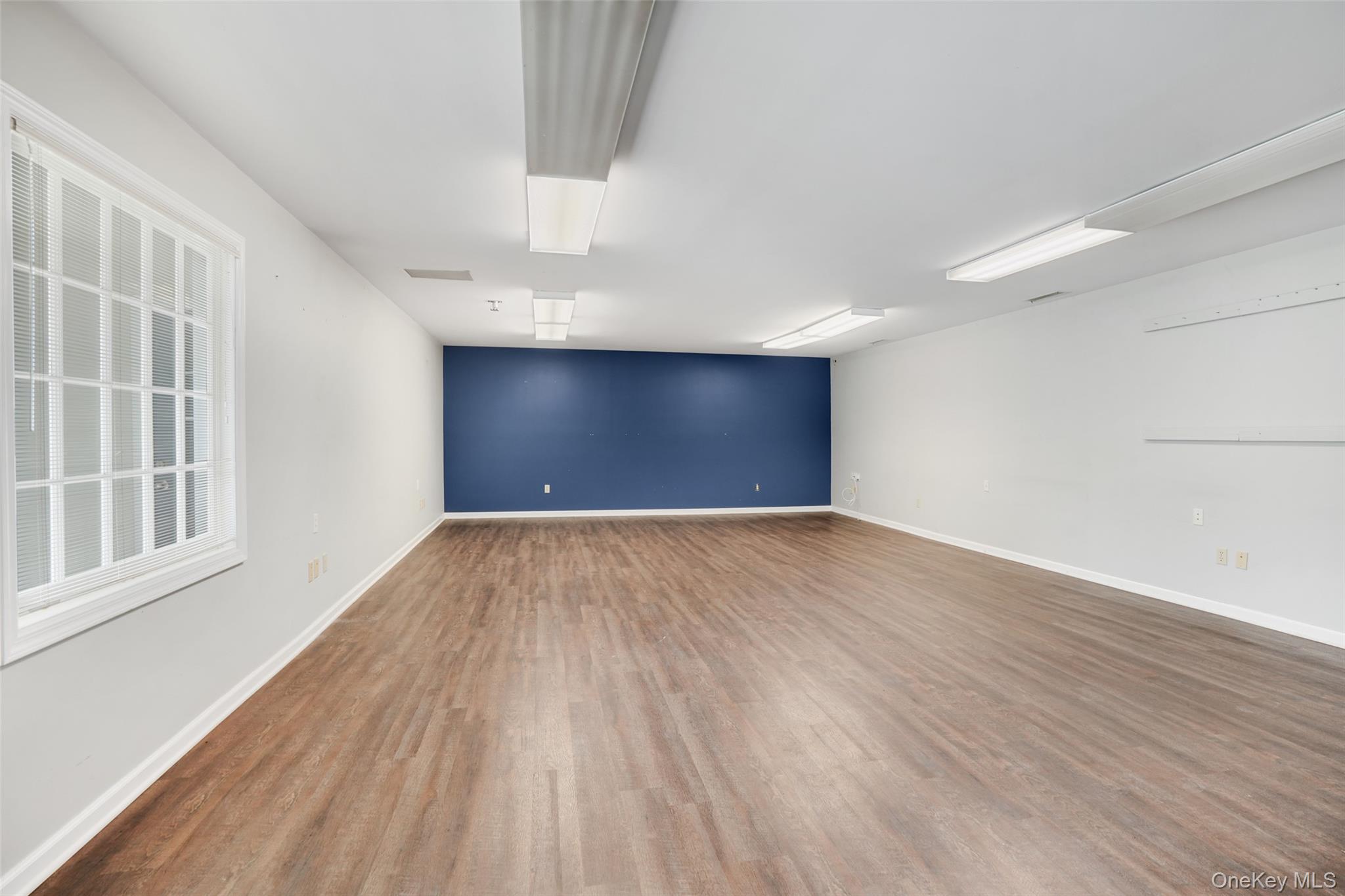 Empty room featuring wood finished floors and baseboards