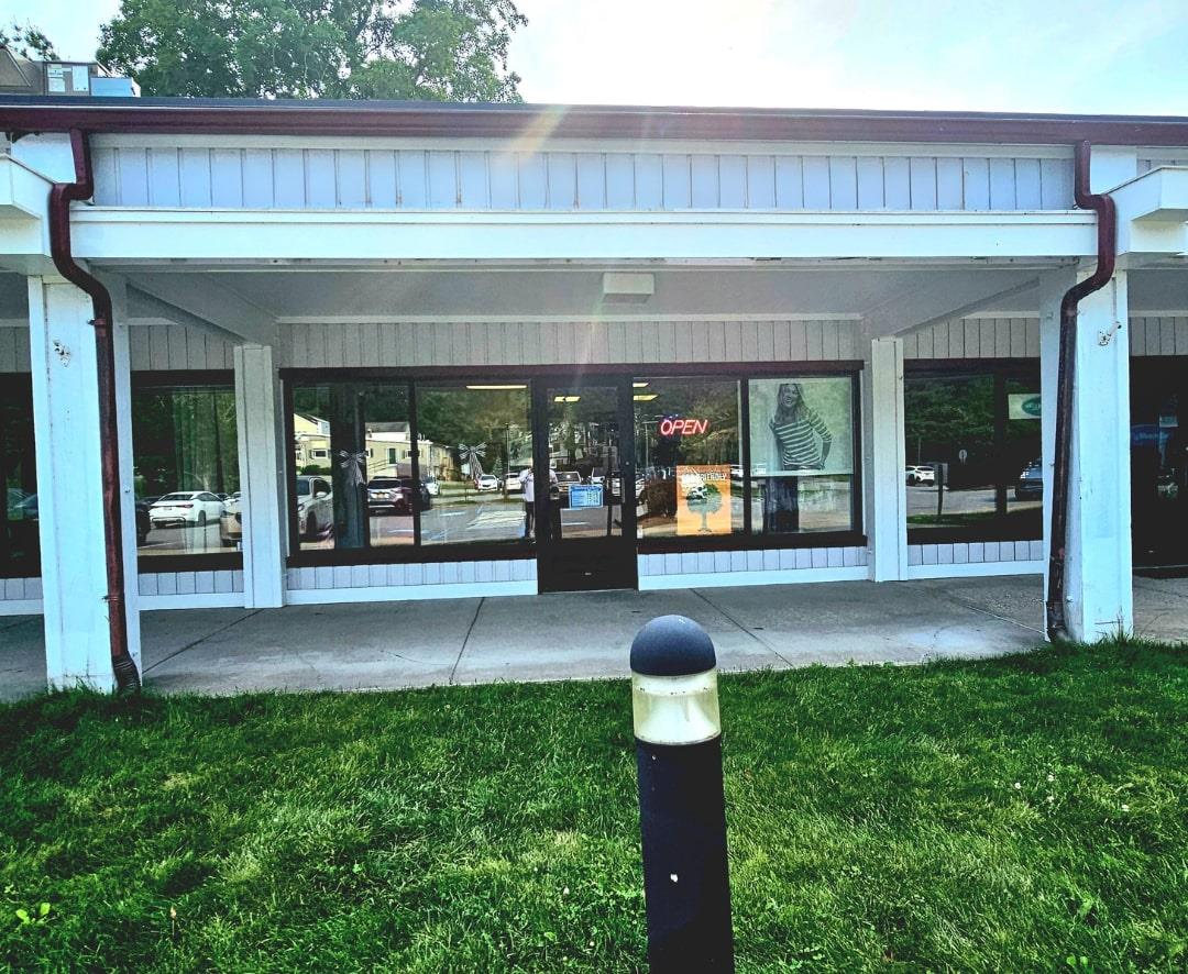 Doorway to property with a lawn