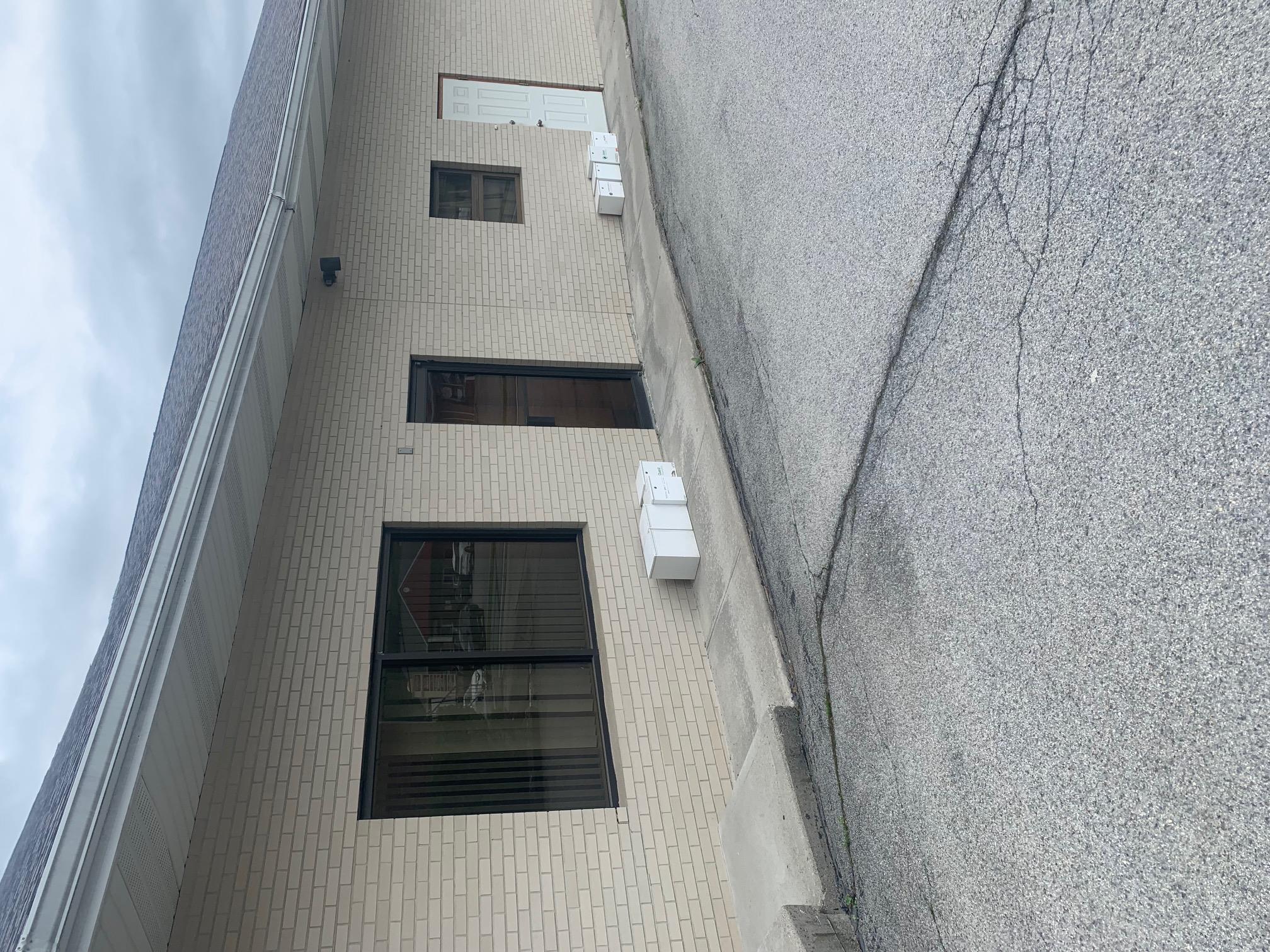 Property entrance featuring brick siding