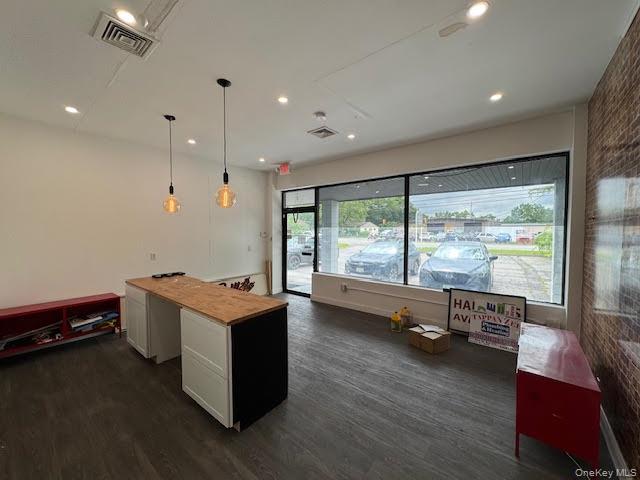 Reception featuring dark wood-style floors, pendant lighting, recessed lighting