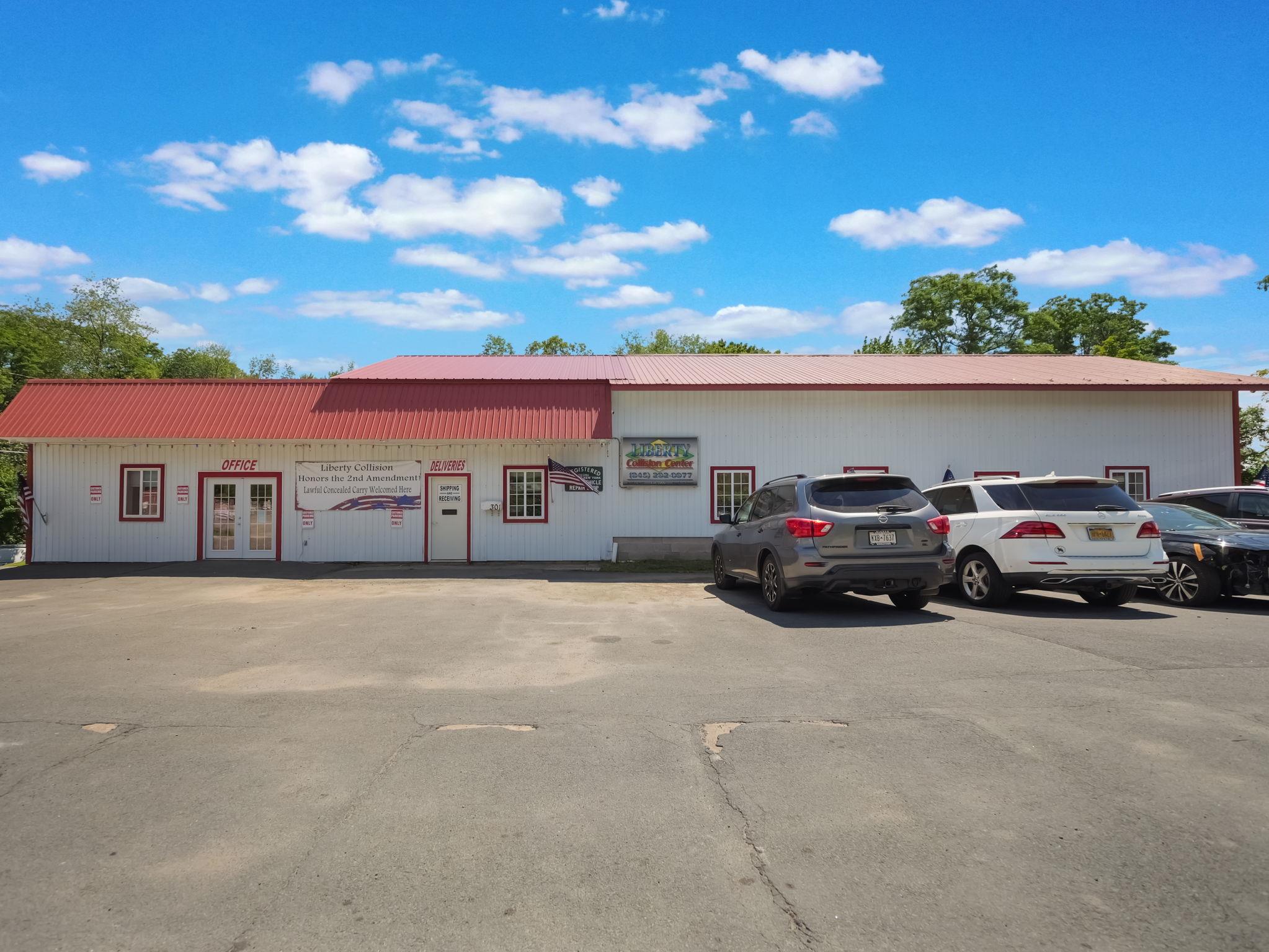 View of commercial property featuring uncovered parking