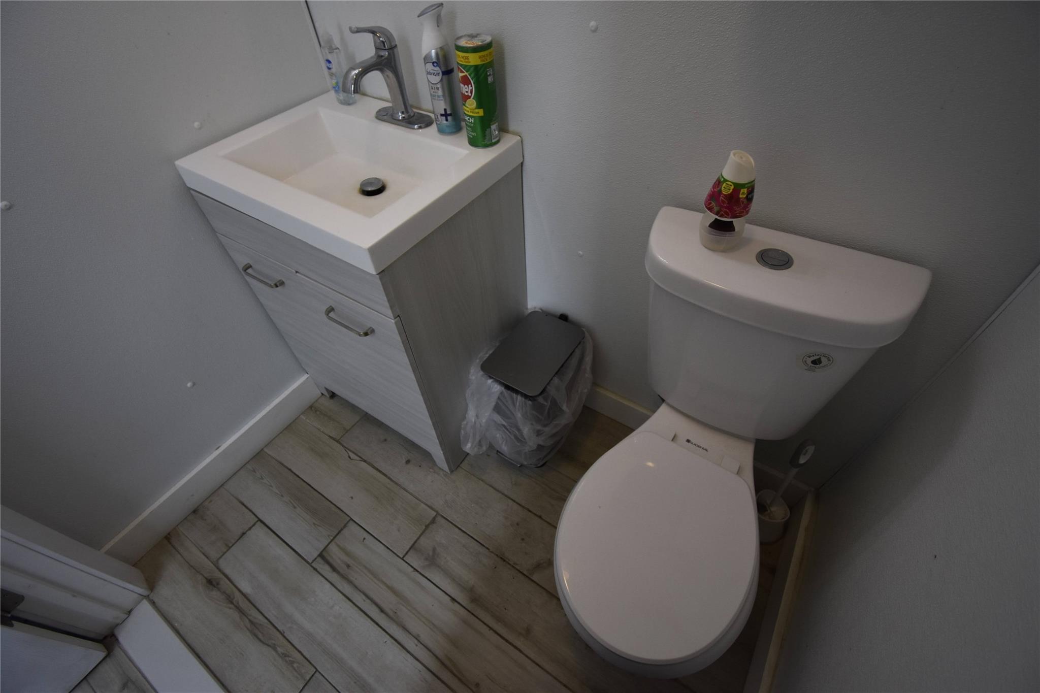 Half bath featuring vanity and wood finished floors