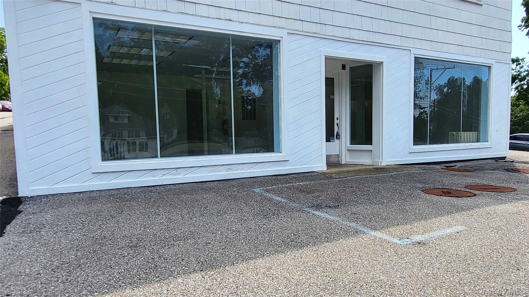 Doorway to property with uncovered parking