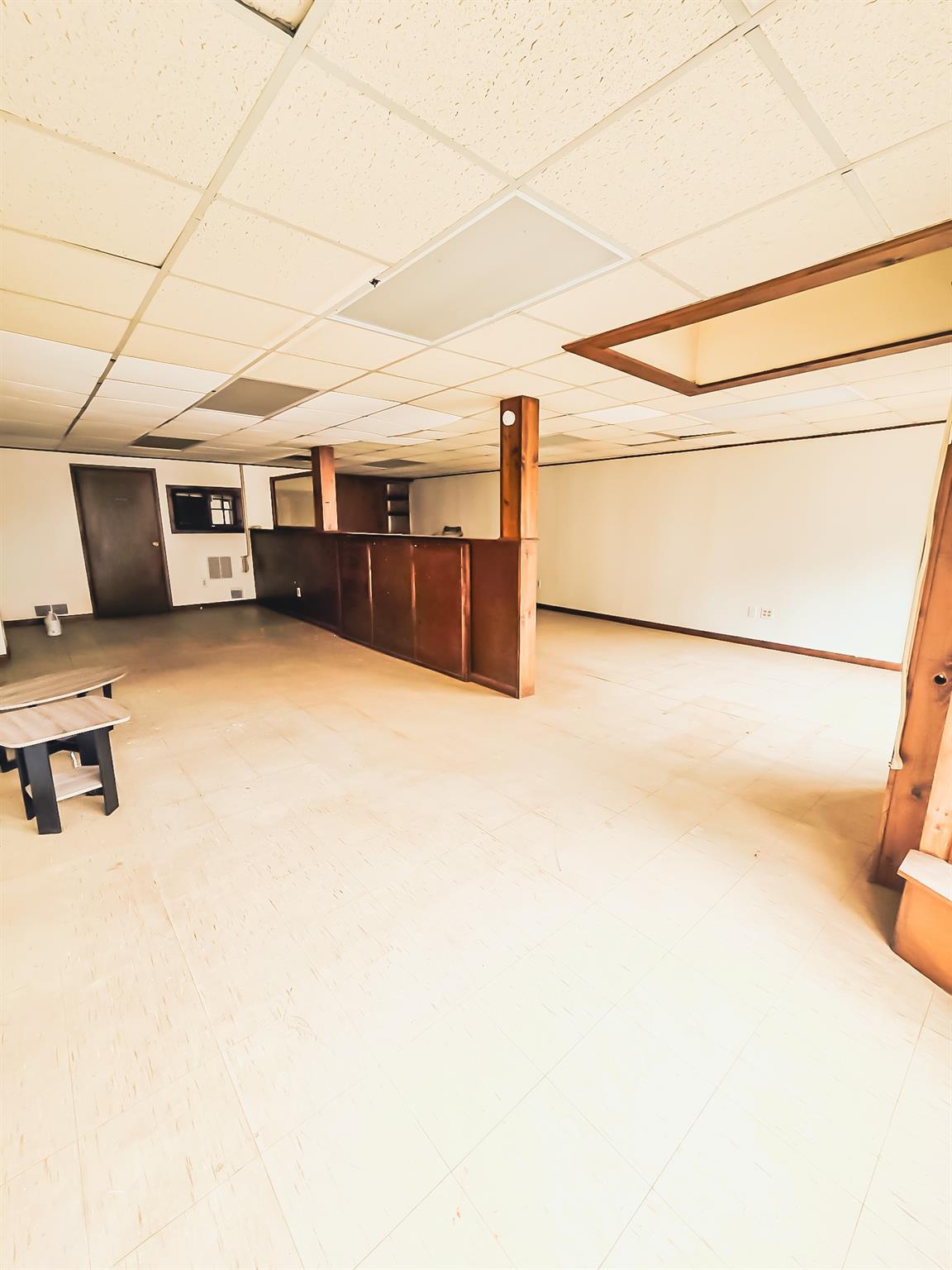 Studio featuring a paneled ceiling and bar area