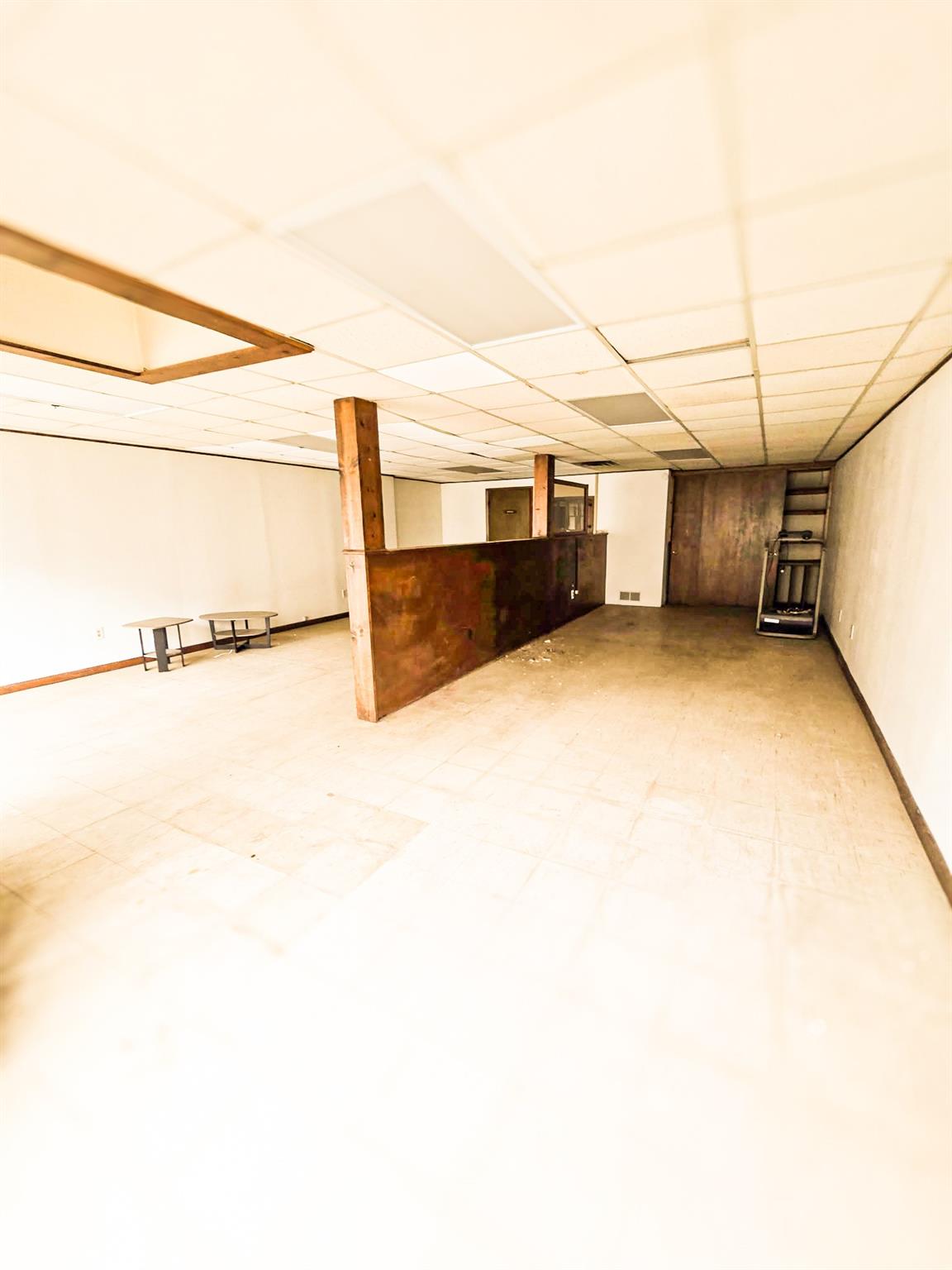 Studio with tile patterned floors and a paneled ceiling