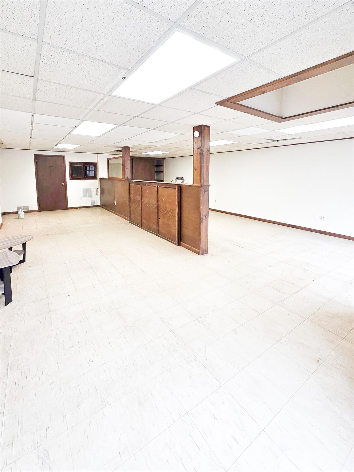 Studio area featuring tile patterned floors and a drop ceiling