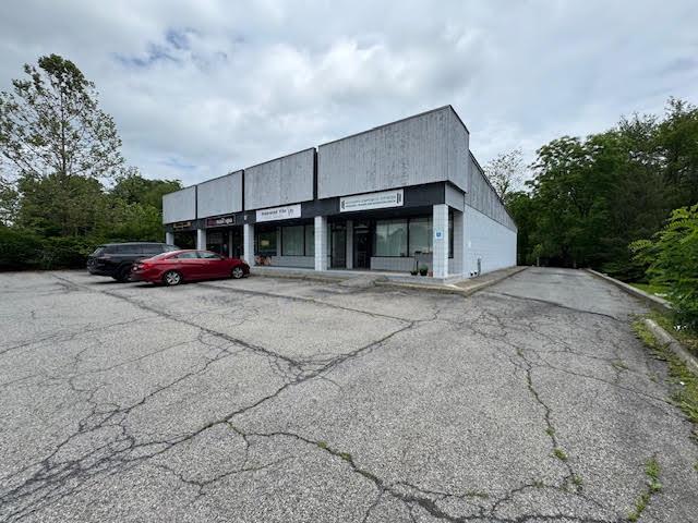 View of property with parking area and driveway to the back of the property.