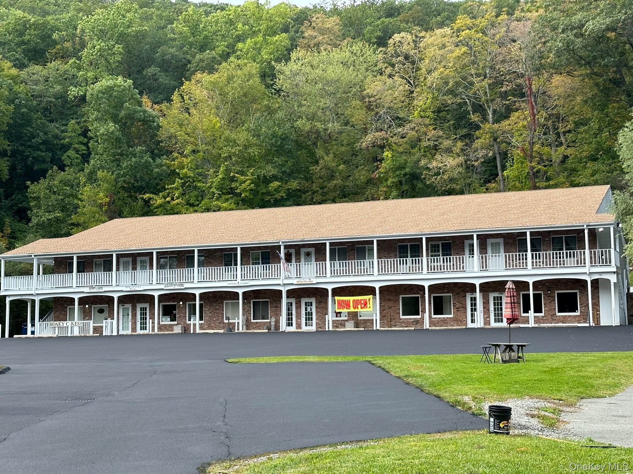View of building exterior with plenty of parking!