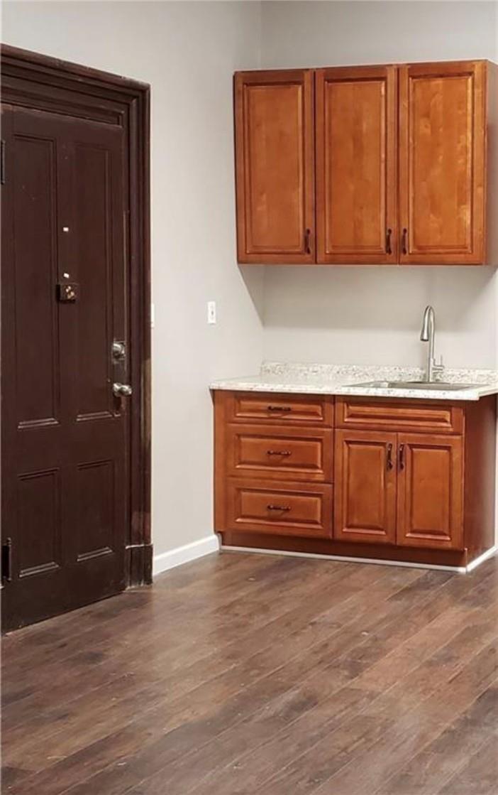 Kitchen with dark hardwood / wood-style floors and sink