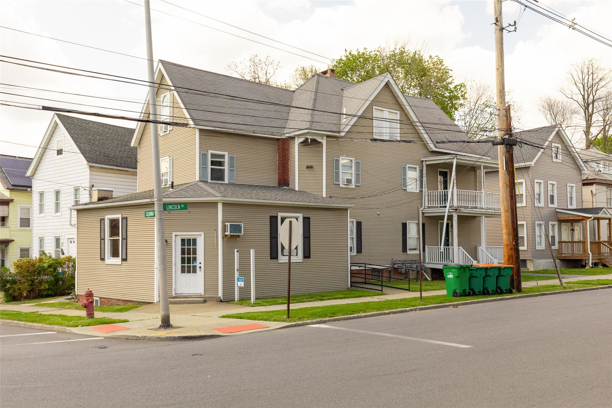 View of front of property with a chimney and a shingled roof