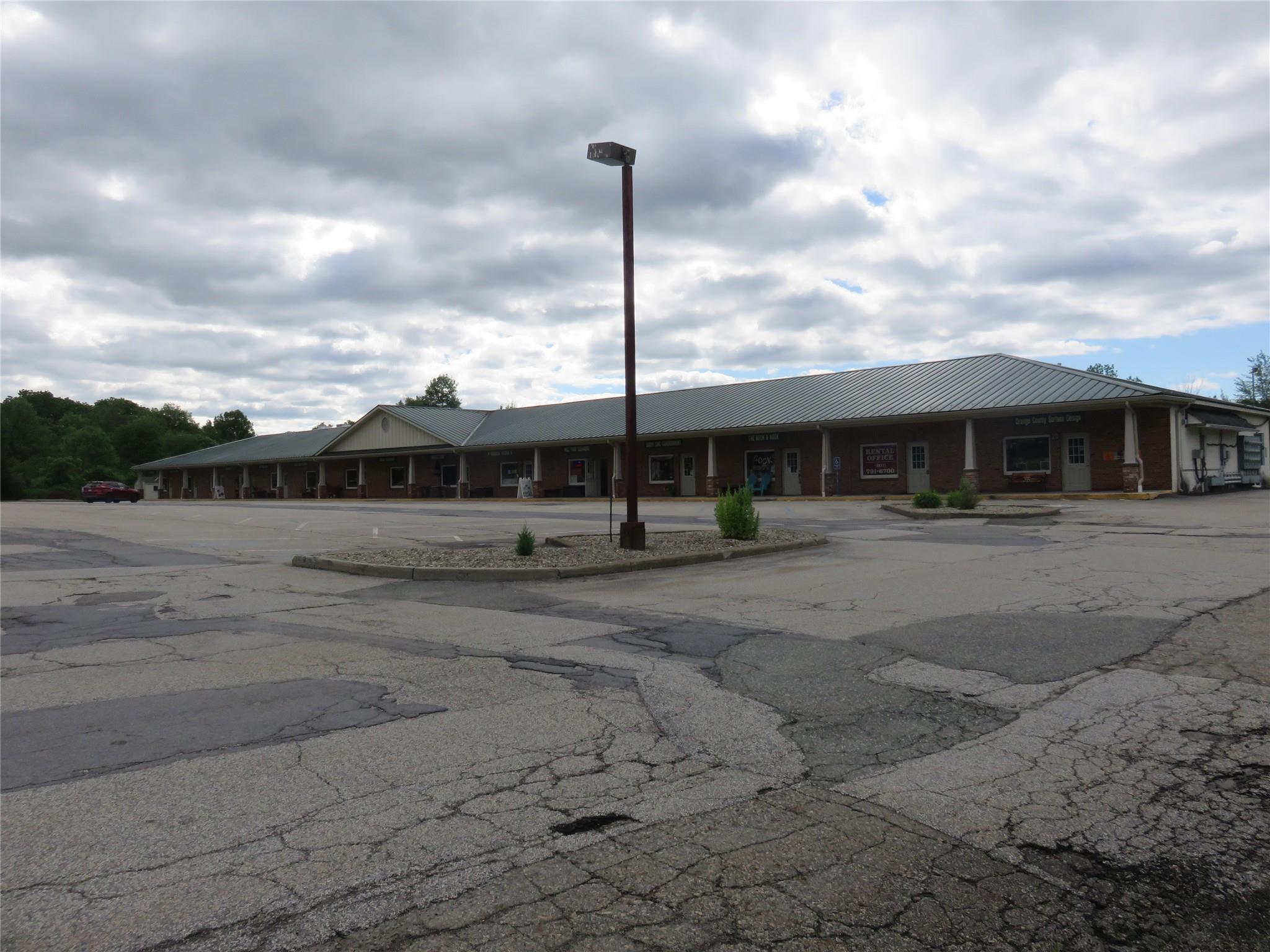 View of property featuring uncovered parking