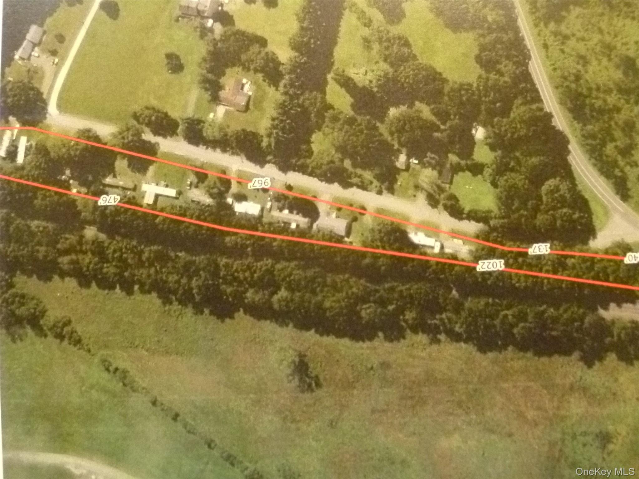 Aerial view of property and surrounding area featuring property parcel outlined
