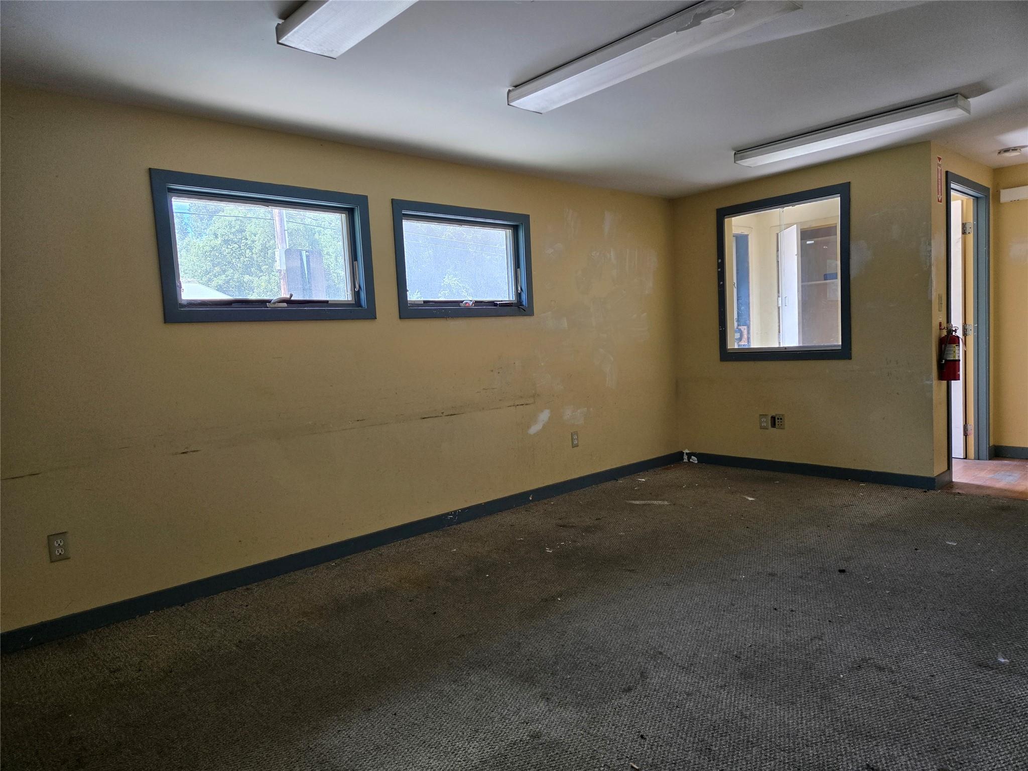 Empty room featuring baseboards and carpet