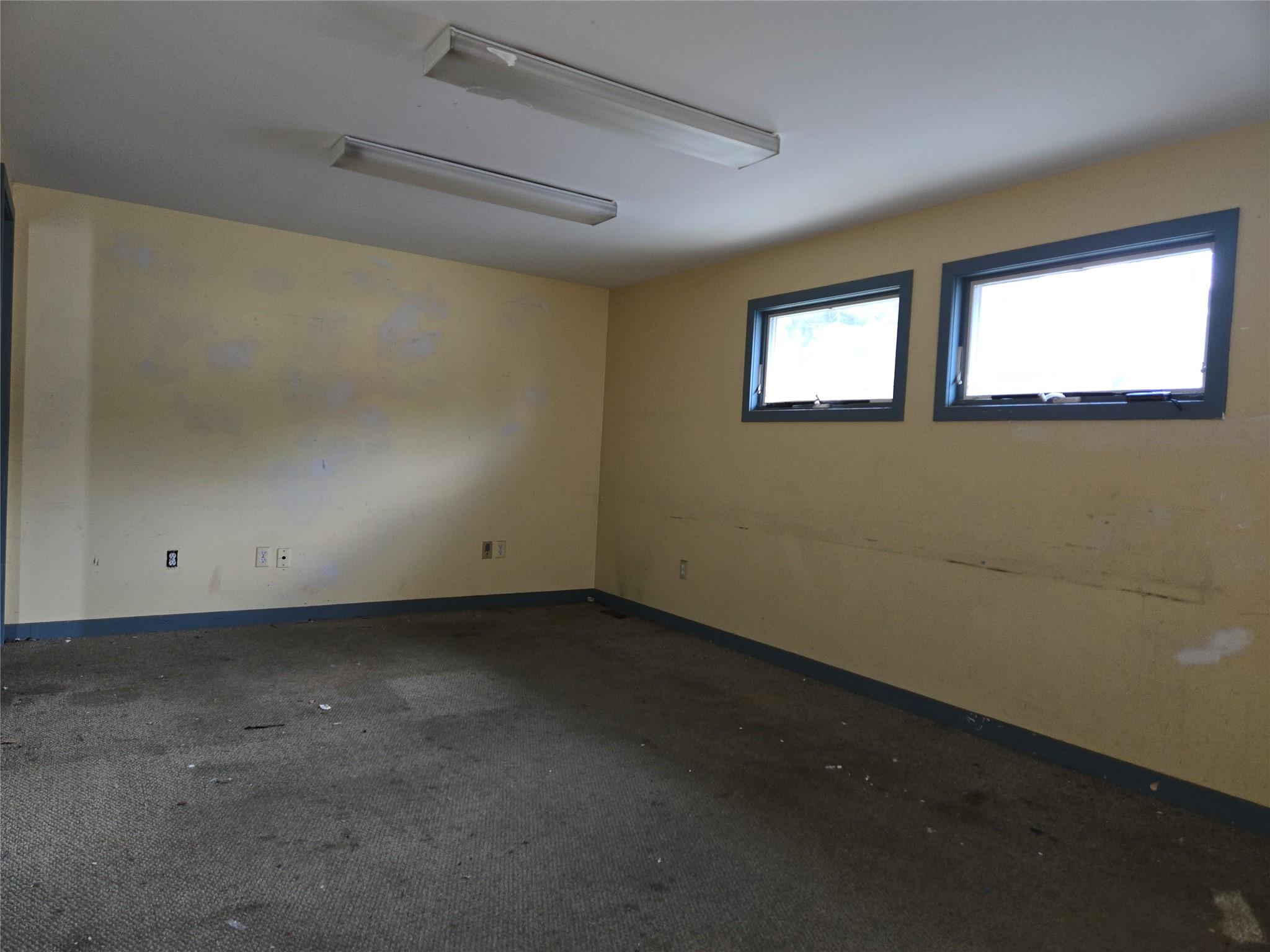 Spare room featuring baseboards and carpet