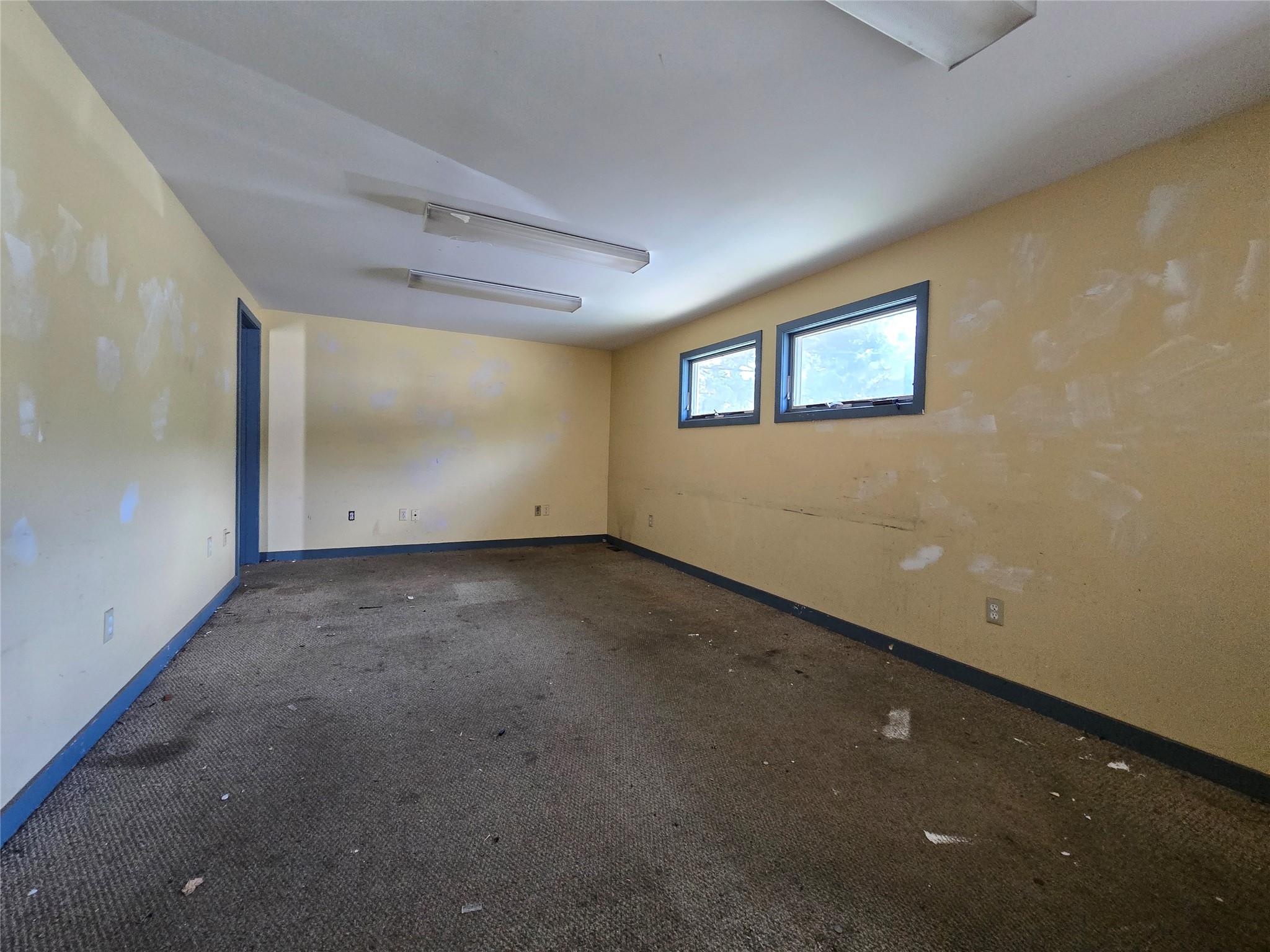 Spare room with baseboards and carpet floors