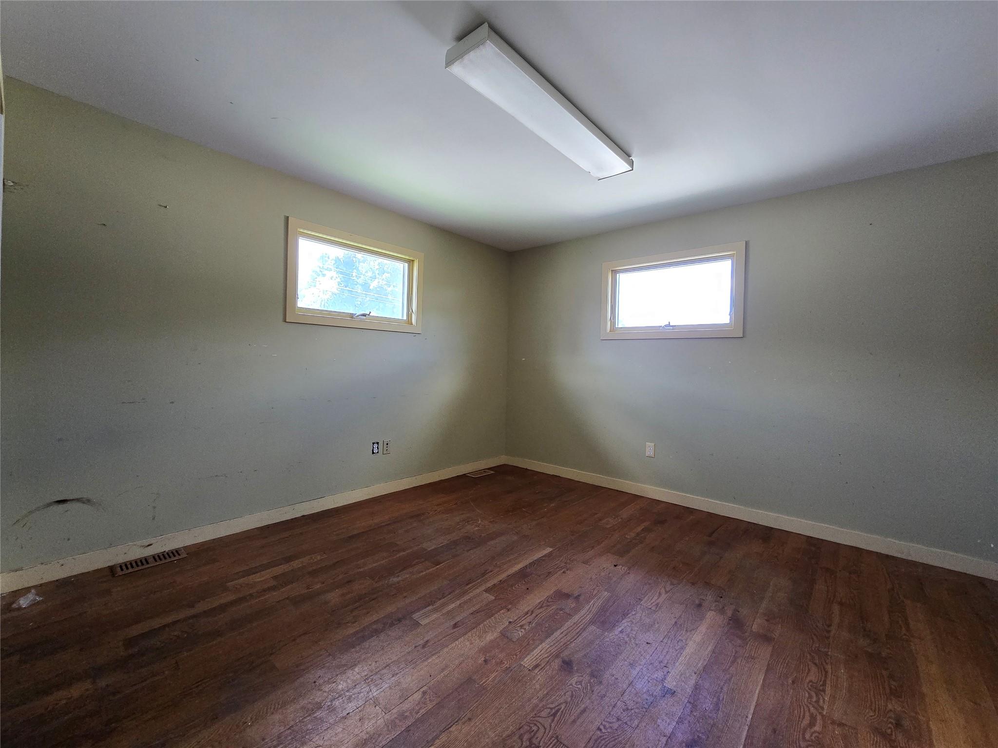 Empty room with wood finished floors and baseboards
