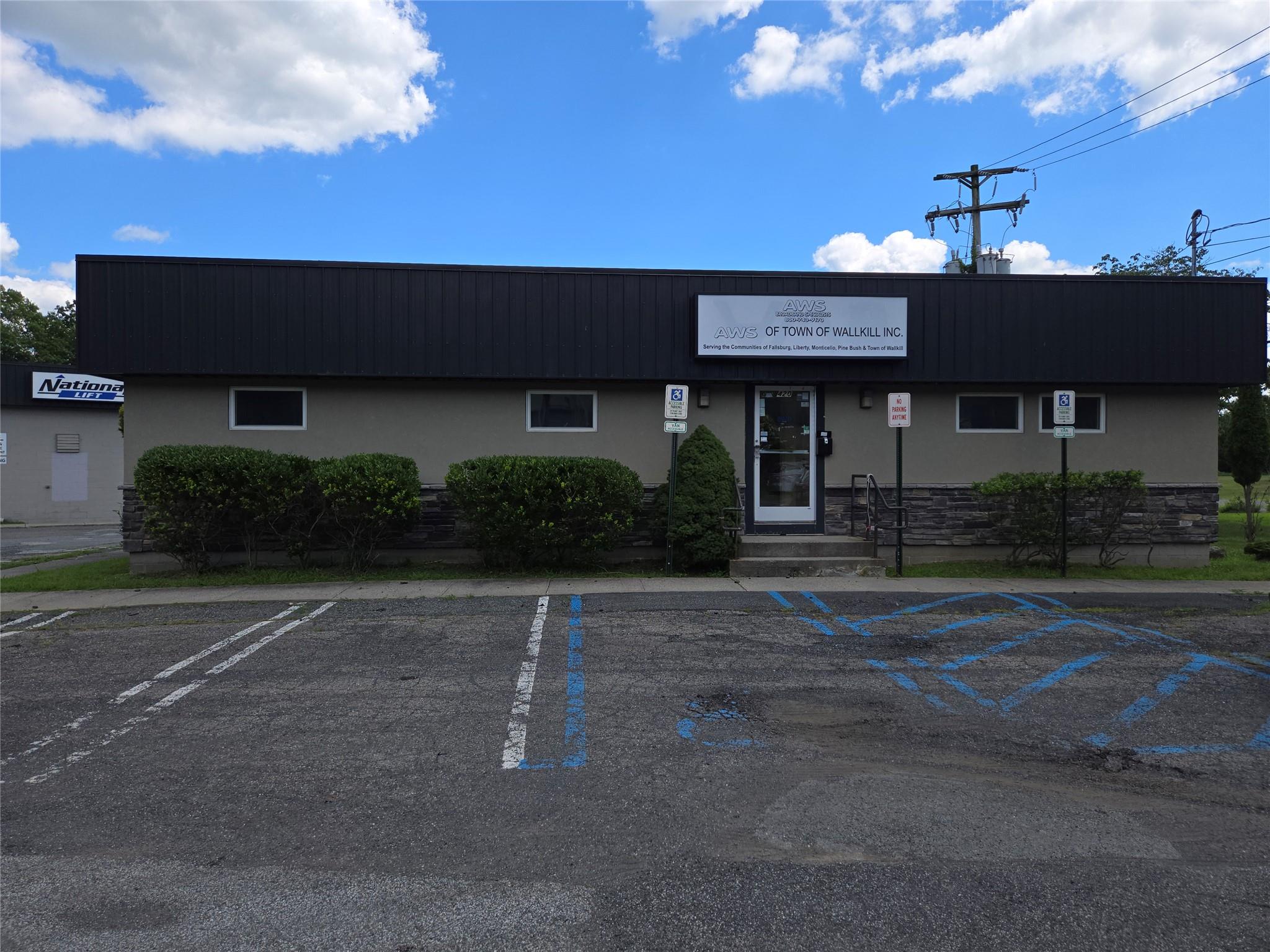 View of property featuring uncovered parking