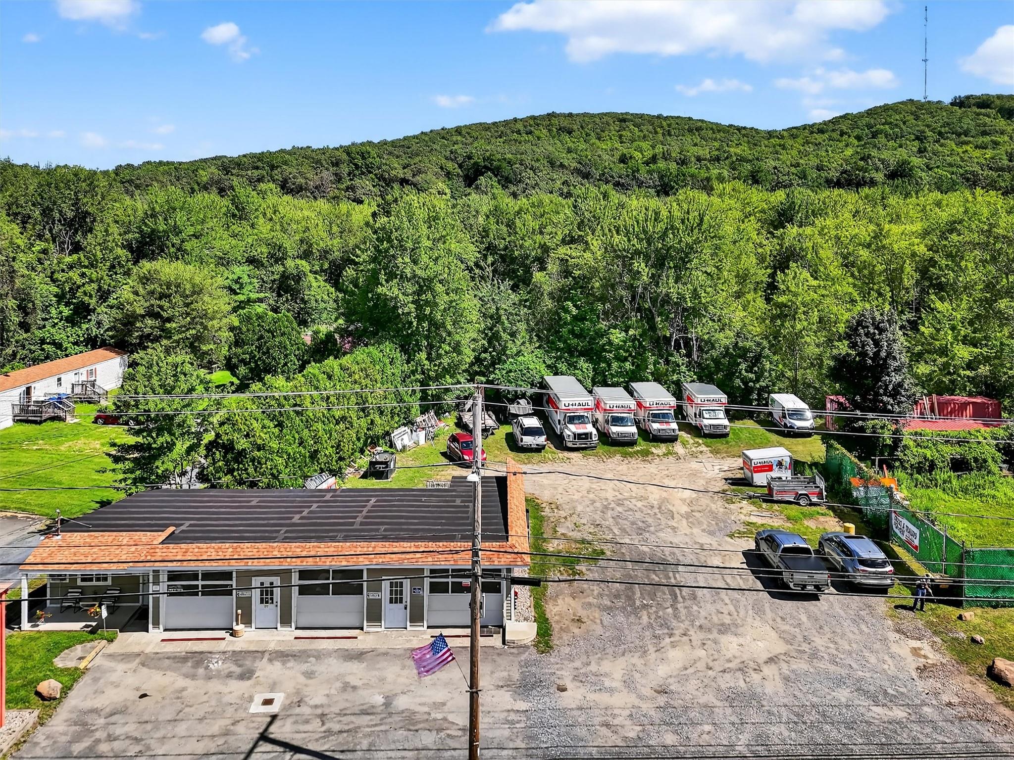 View of subject property with a wooded area