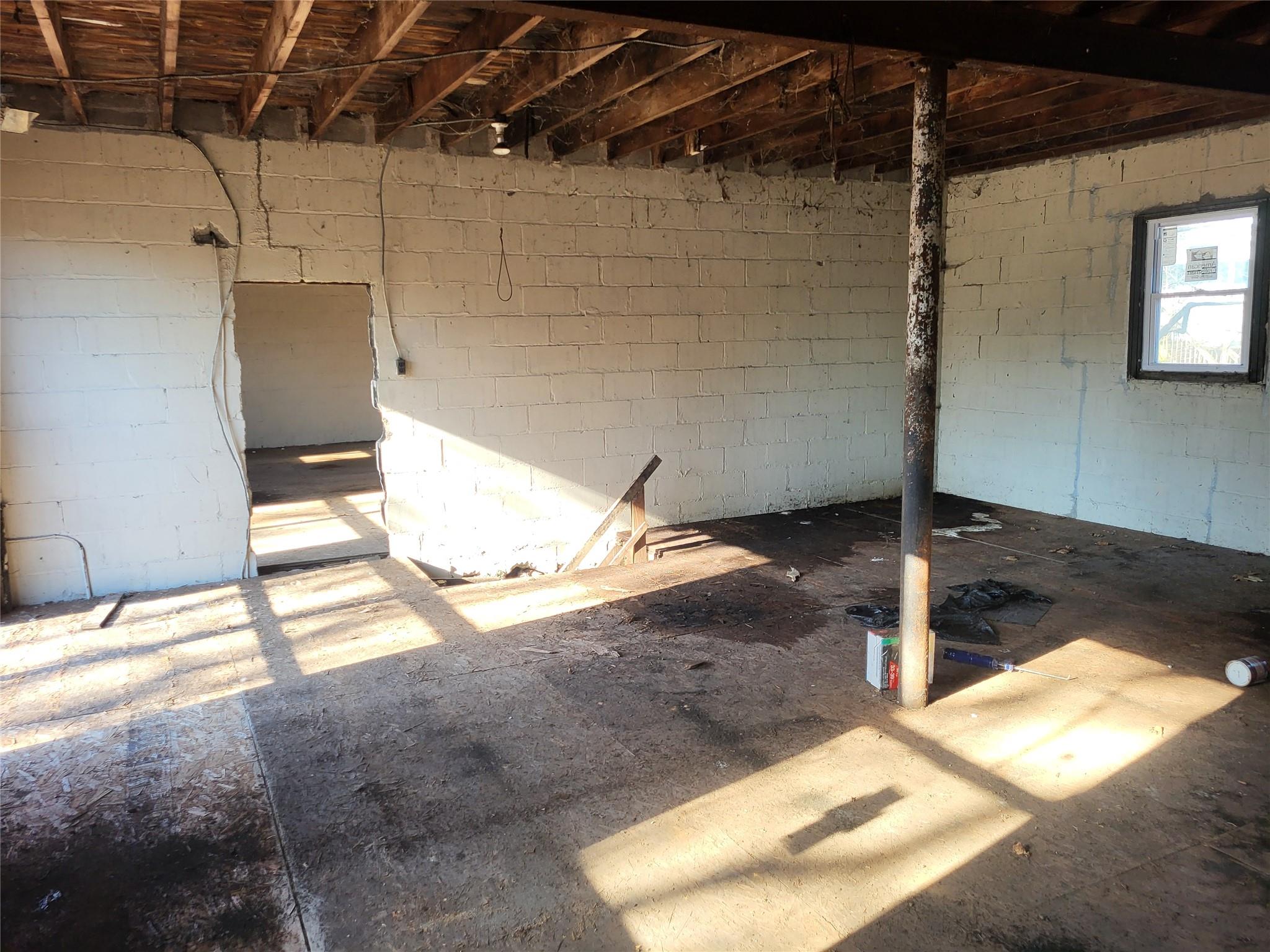 Basement featuring concrete block wall