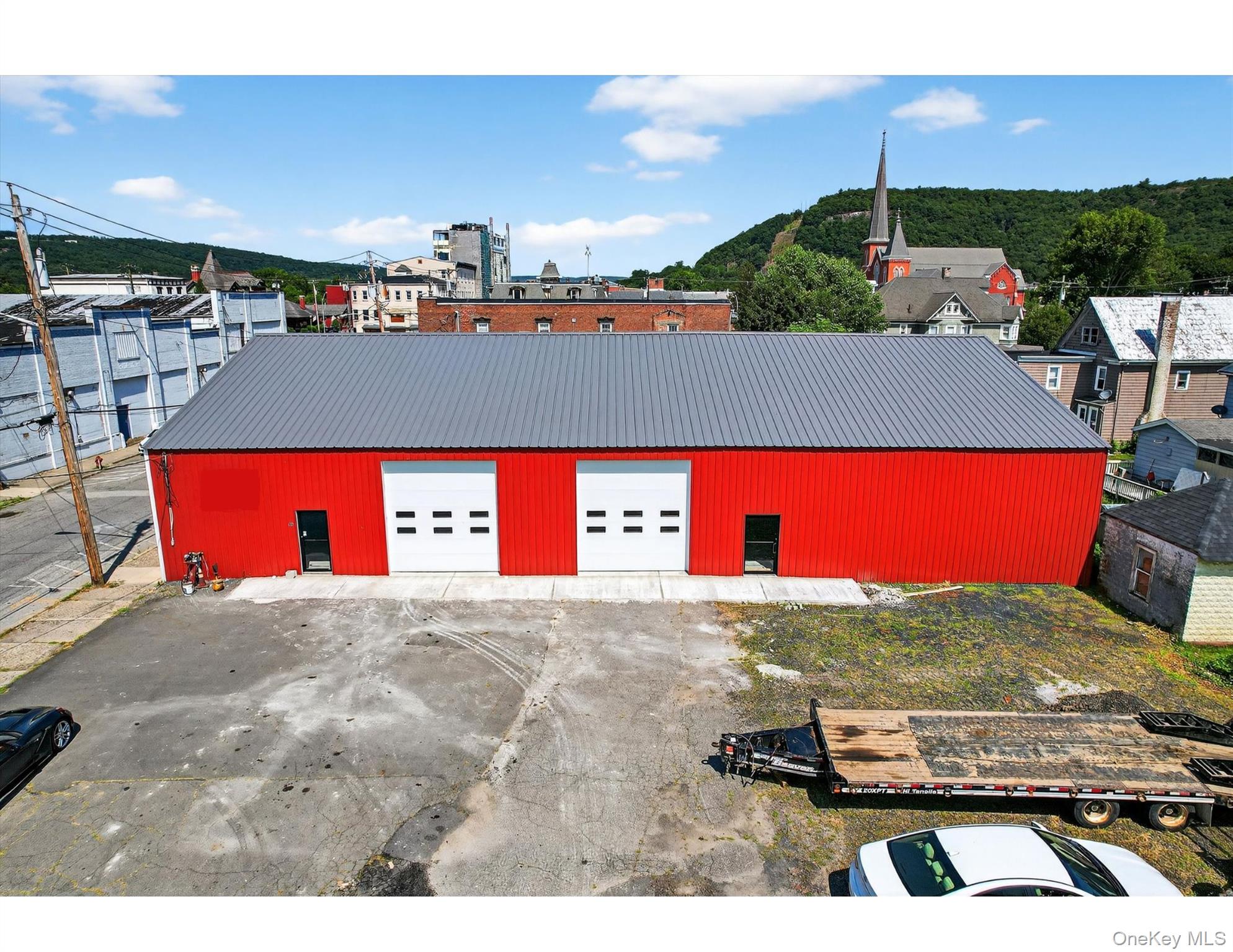 front of building, can see new roof, showing partial parking.