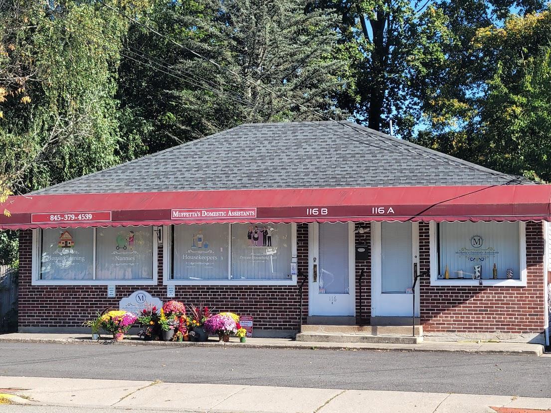 View of front facade featuring a shingled roof and brick siding