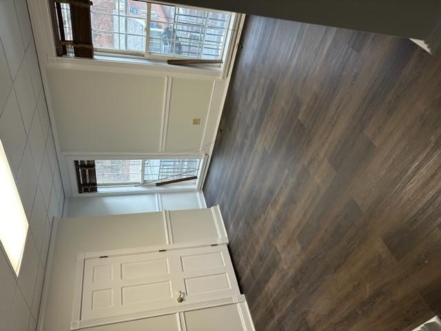 Spare room featuring dark wood finished floors and a paneled ceiling