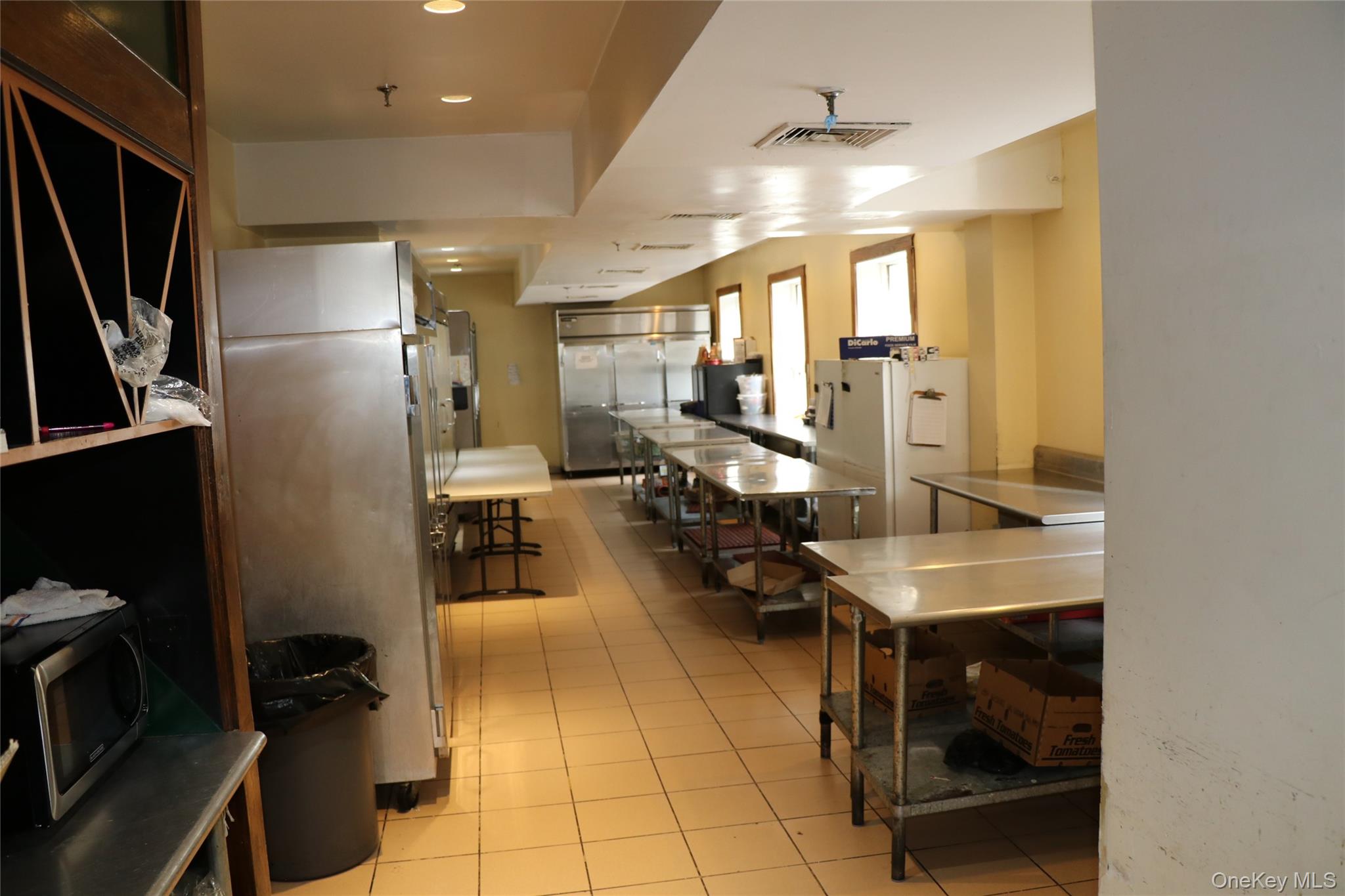 Kitchen featuring stainless steel appliances, light tile patterned floors, and recessed lighting