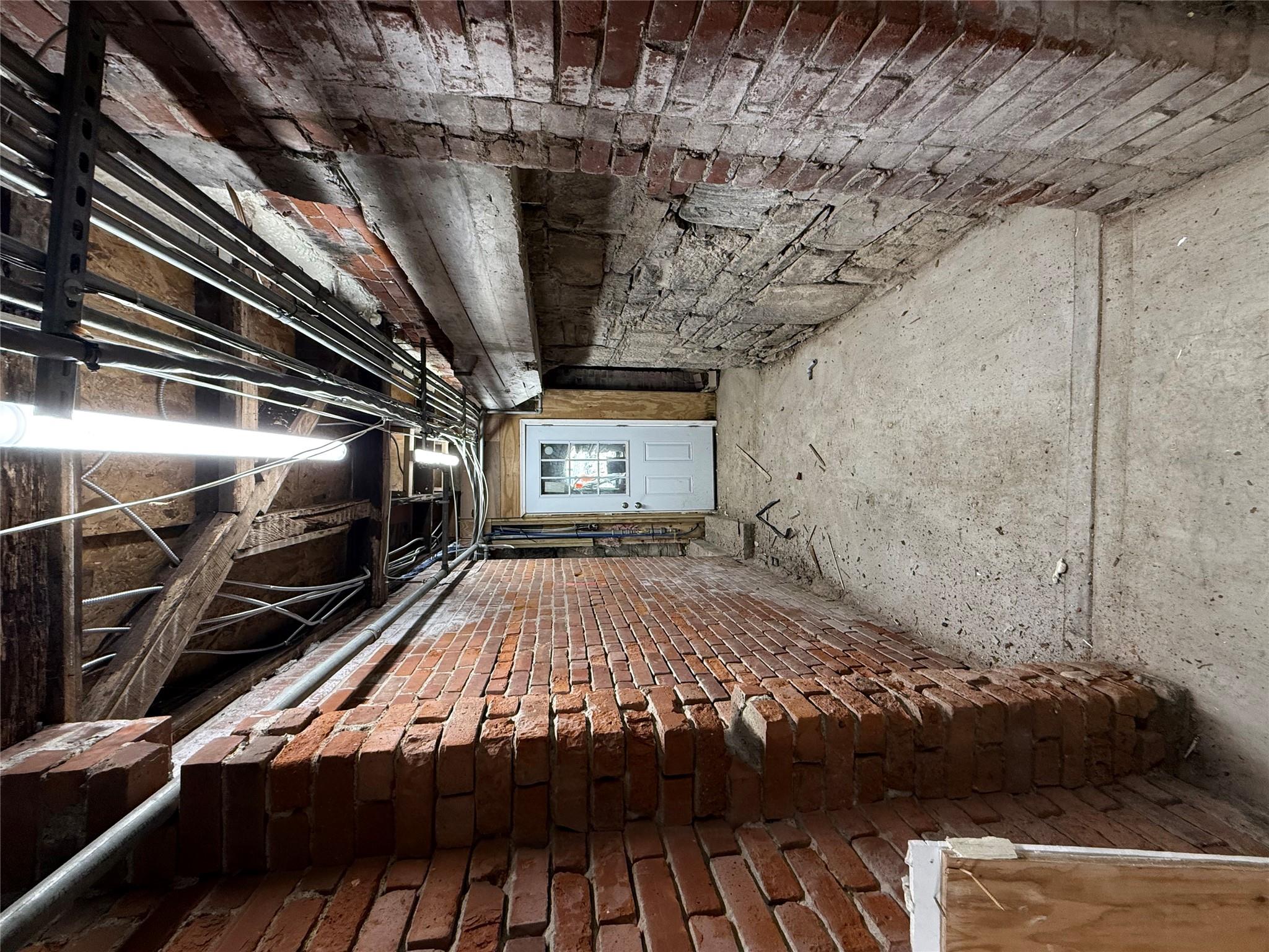 Below grade area featuring brick wall