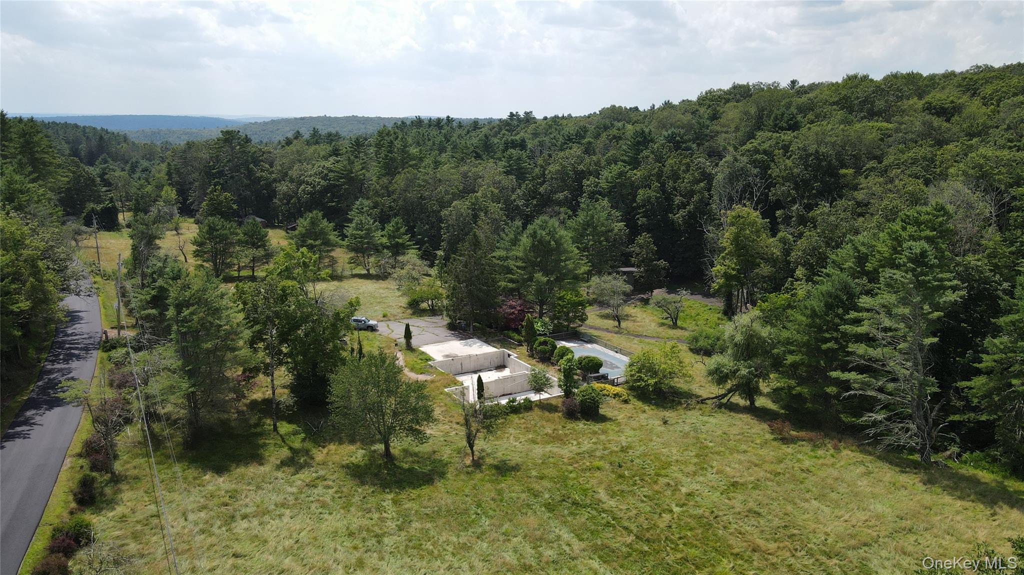 View from above of property with a heavily wooded area
