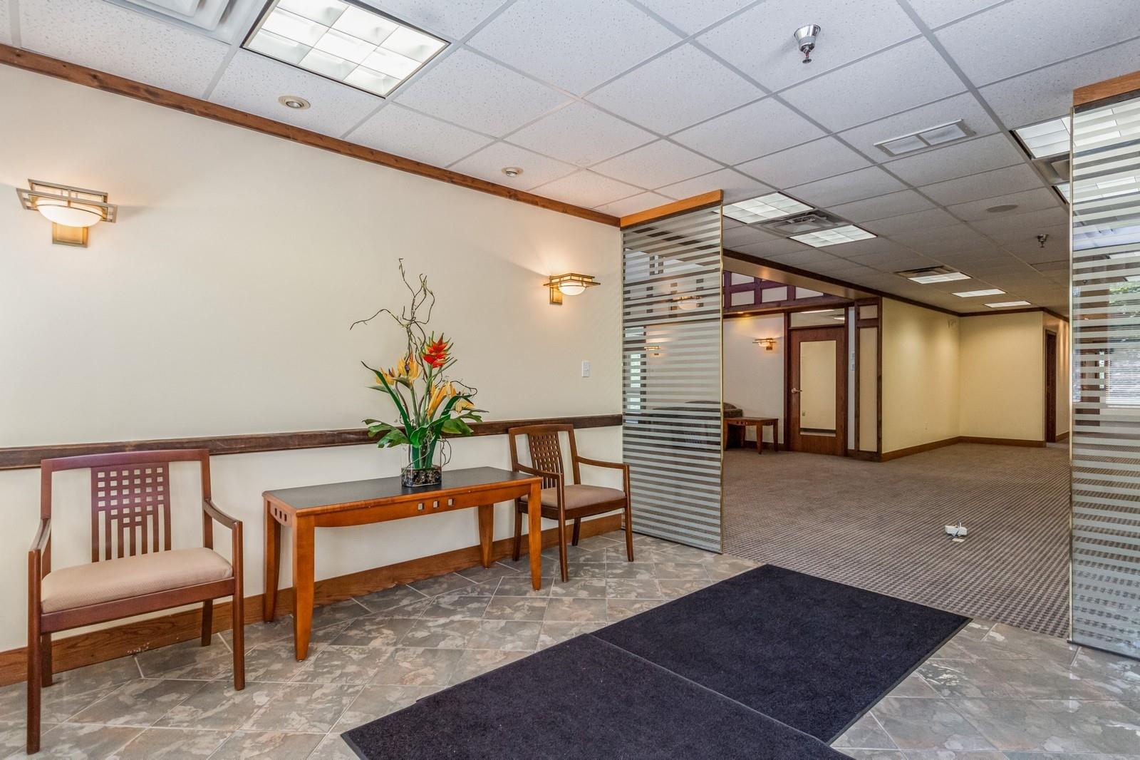 Community lobby featuring a paneled ceiling and ornamental molding