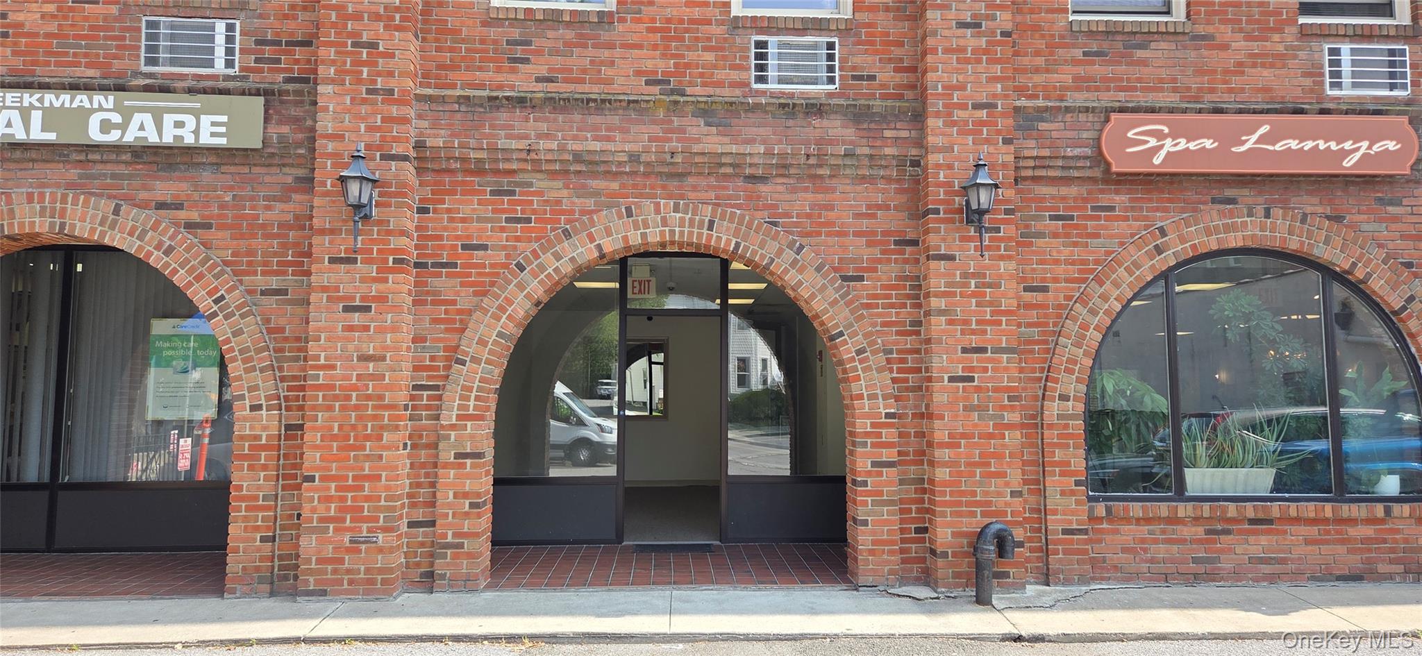 Entrance to property with brick siding