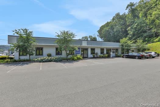 View of property featuring uncovered parking