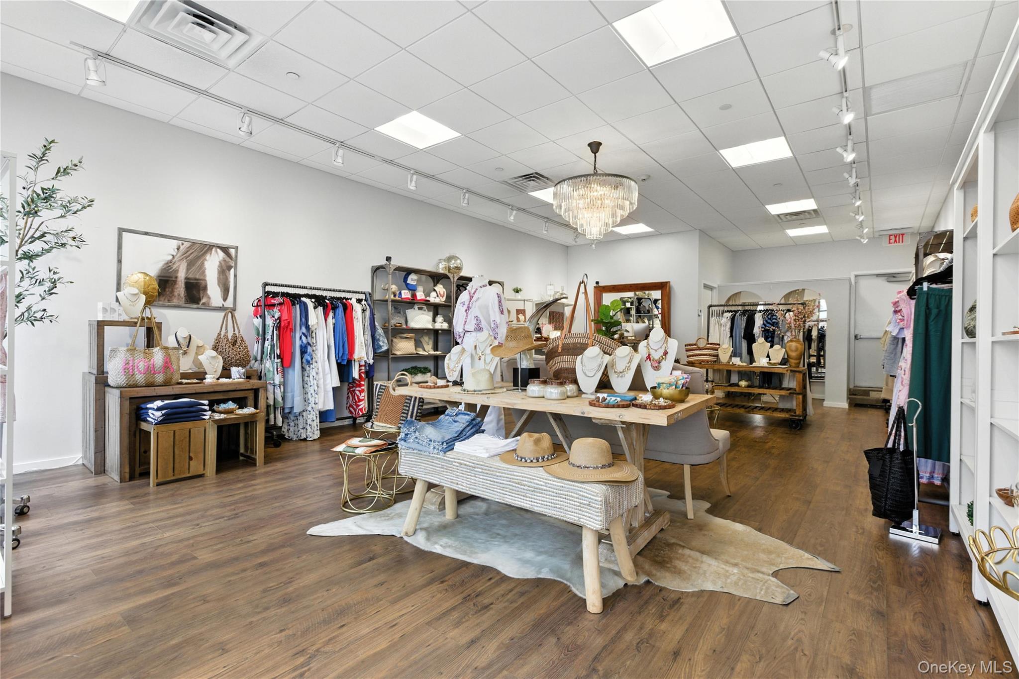 Misc room with rail lighting, a chandelier, wood finished floors, and a drop ceiling