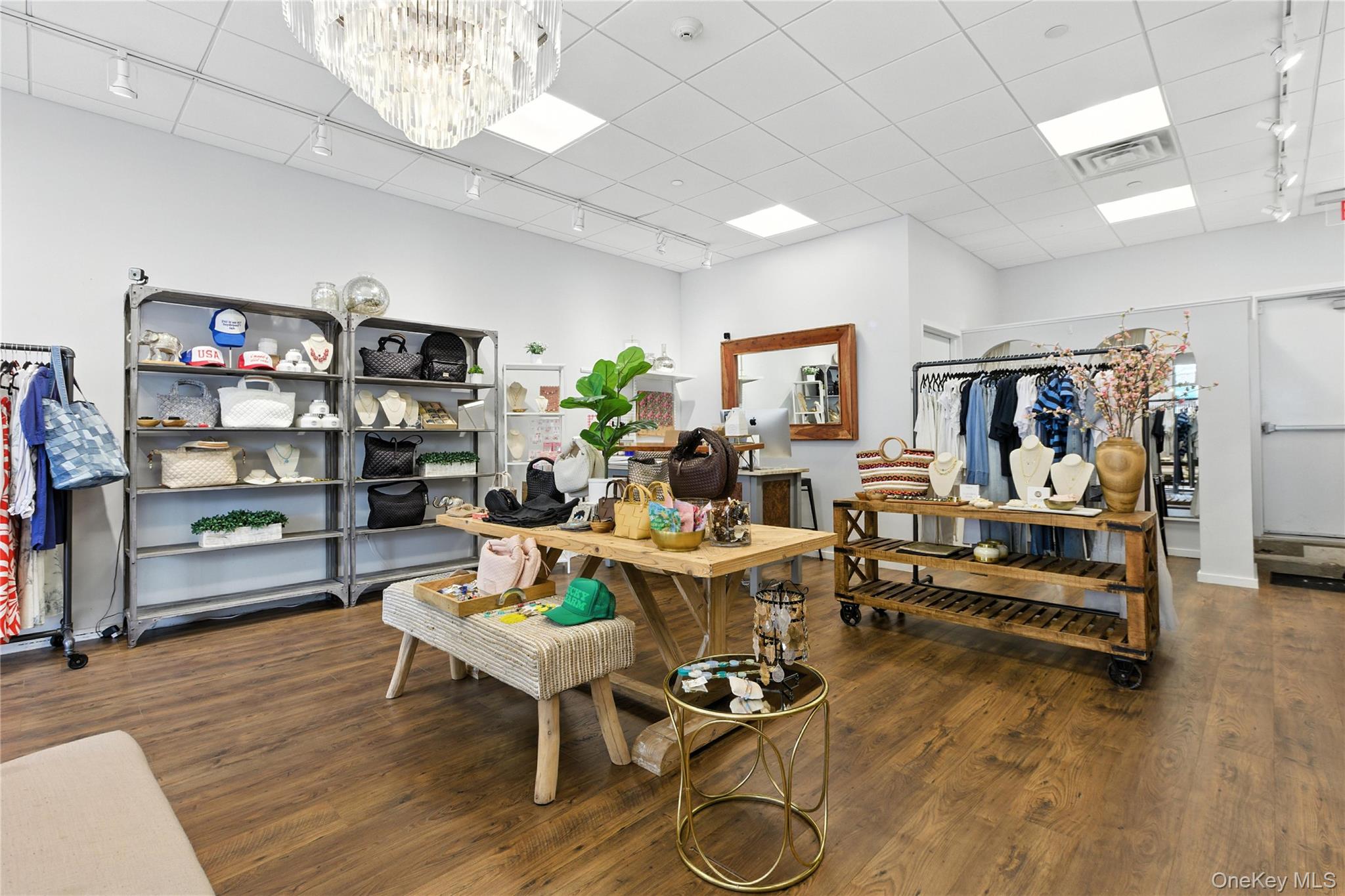 Office featuring track lighting, wood finished floors, a drop ceiling, and a chandelier