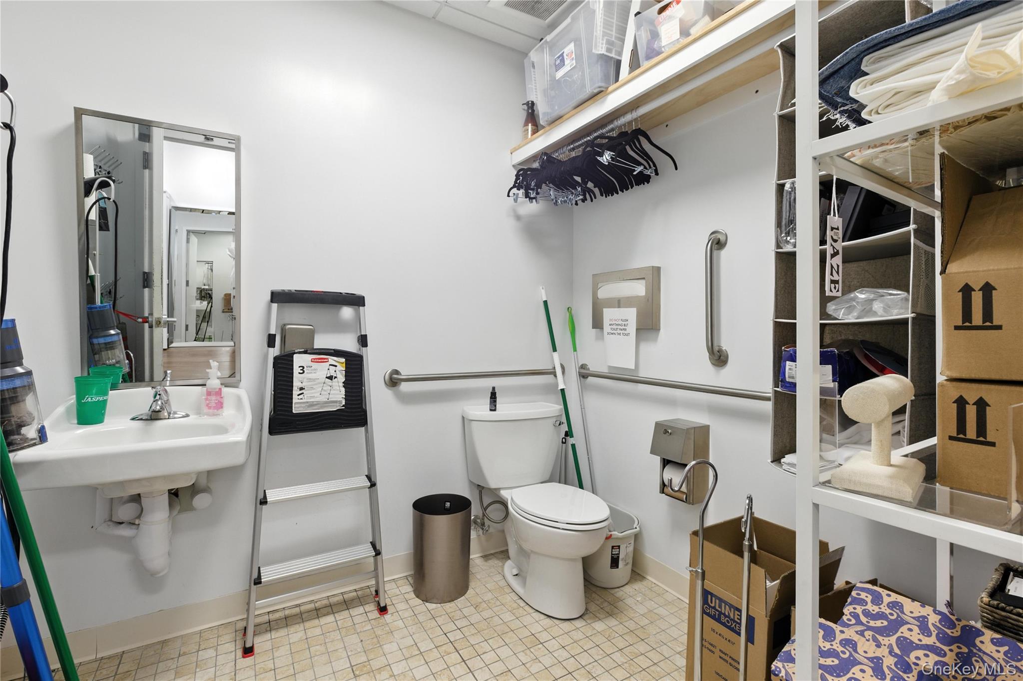 Half bathroom featuring toilet and tile patterned floors