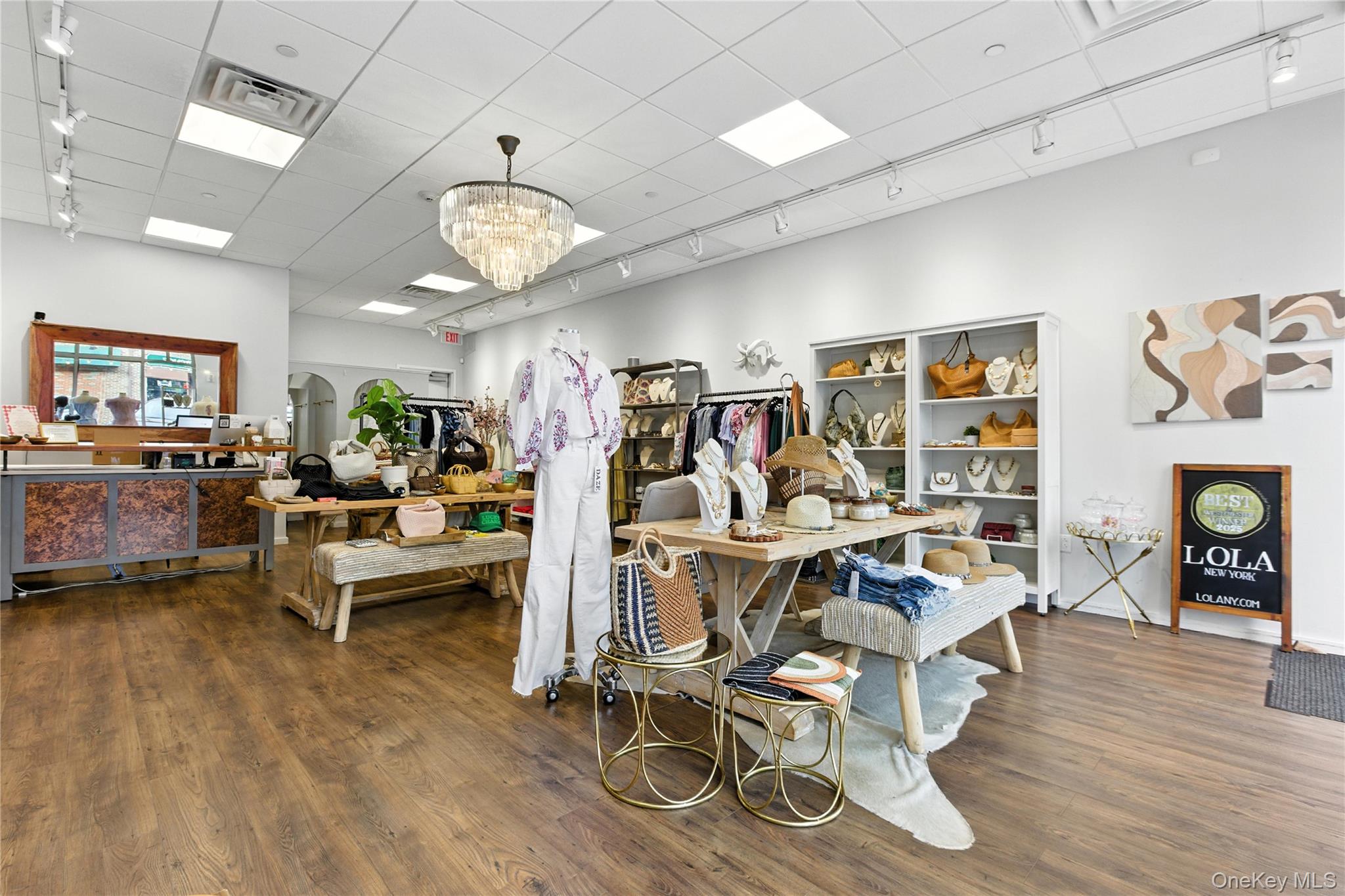 Misc room featuring rail lighting, a chandelier, wood finished floors, and a paneled ceiling