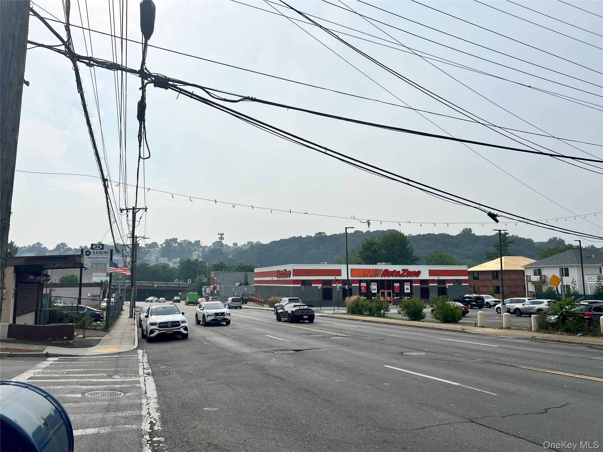 View of asphalt road featuring curbs and traffic signs