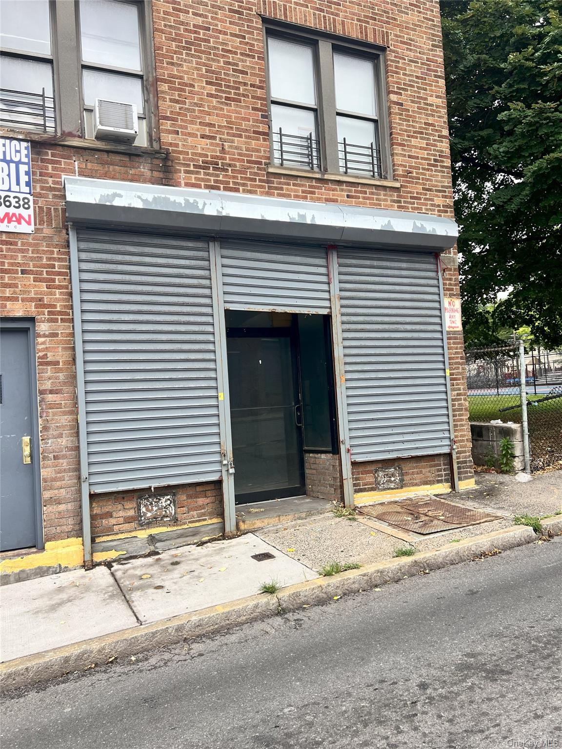 View of exterior entry featuring brick siding