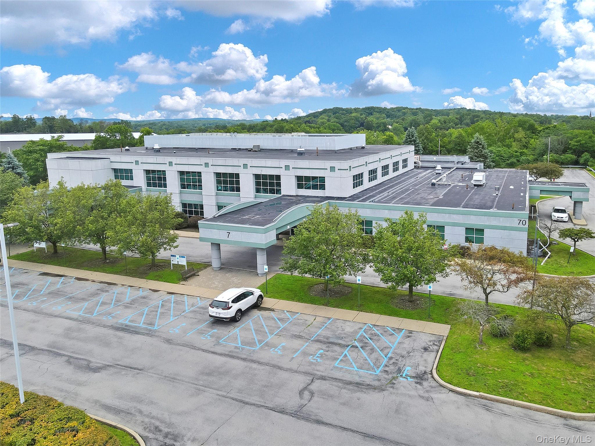 View of property with uncovered parking