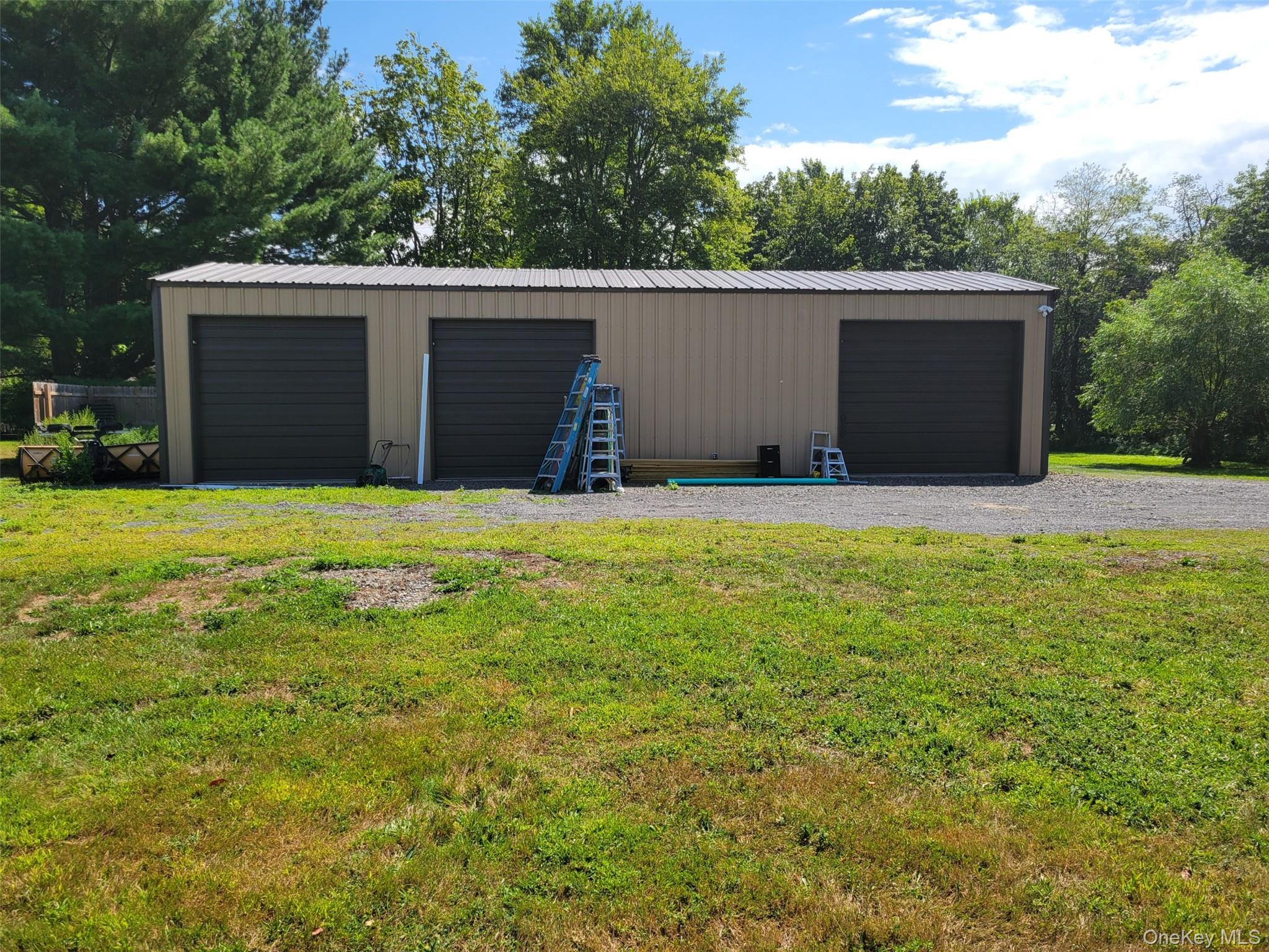 Detached garage with view of scattered trees