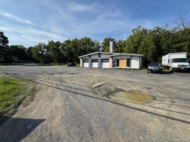 View of front of property featuring a garage and an outdoor structure