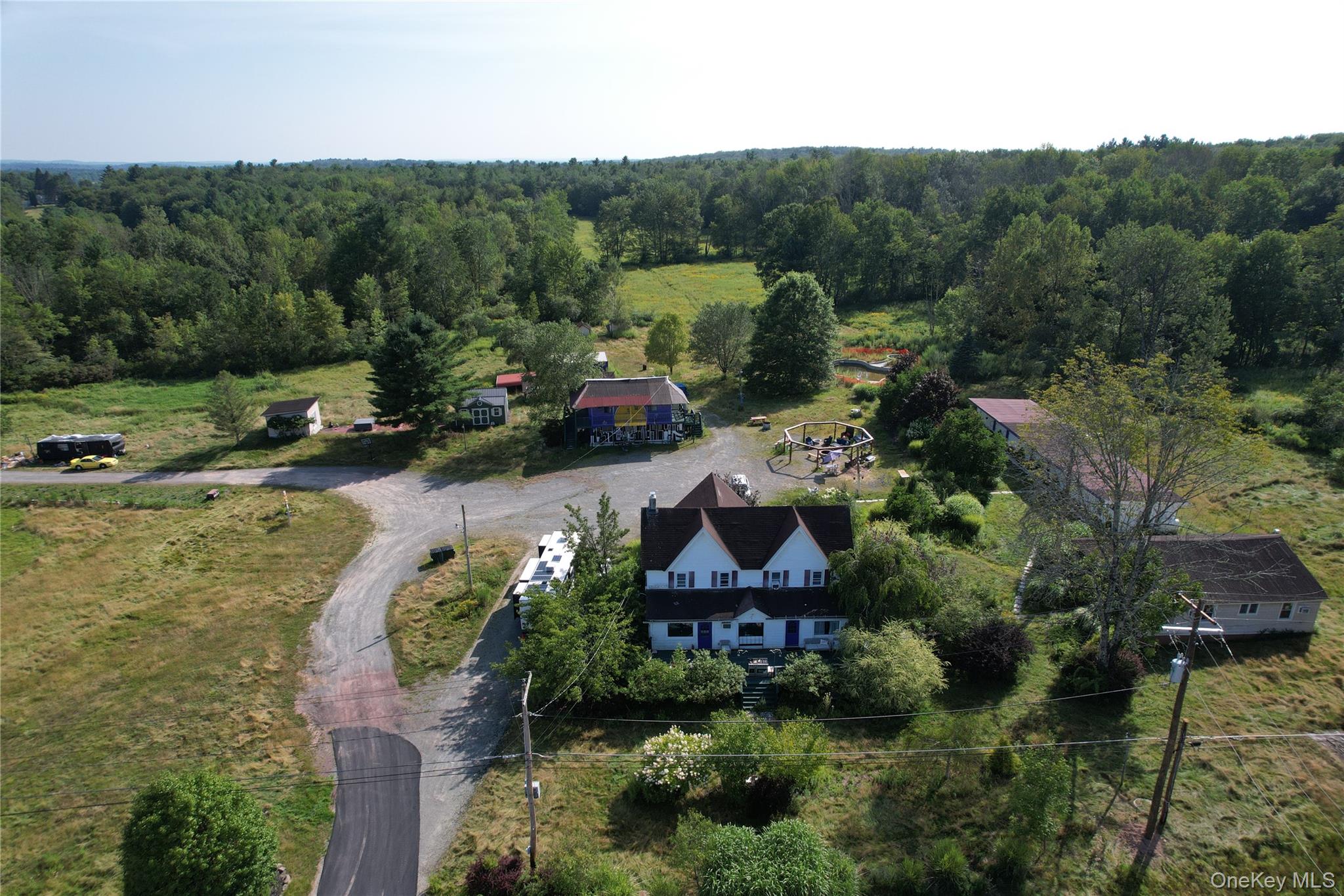 View of subject property with a forest