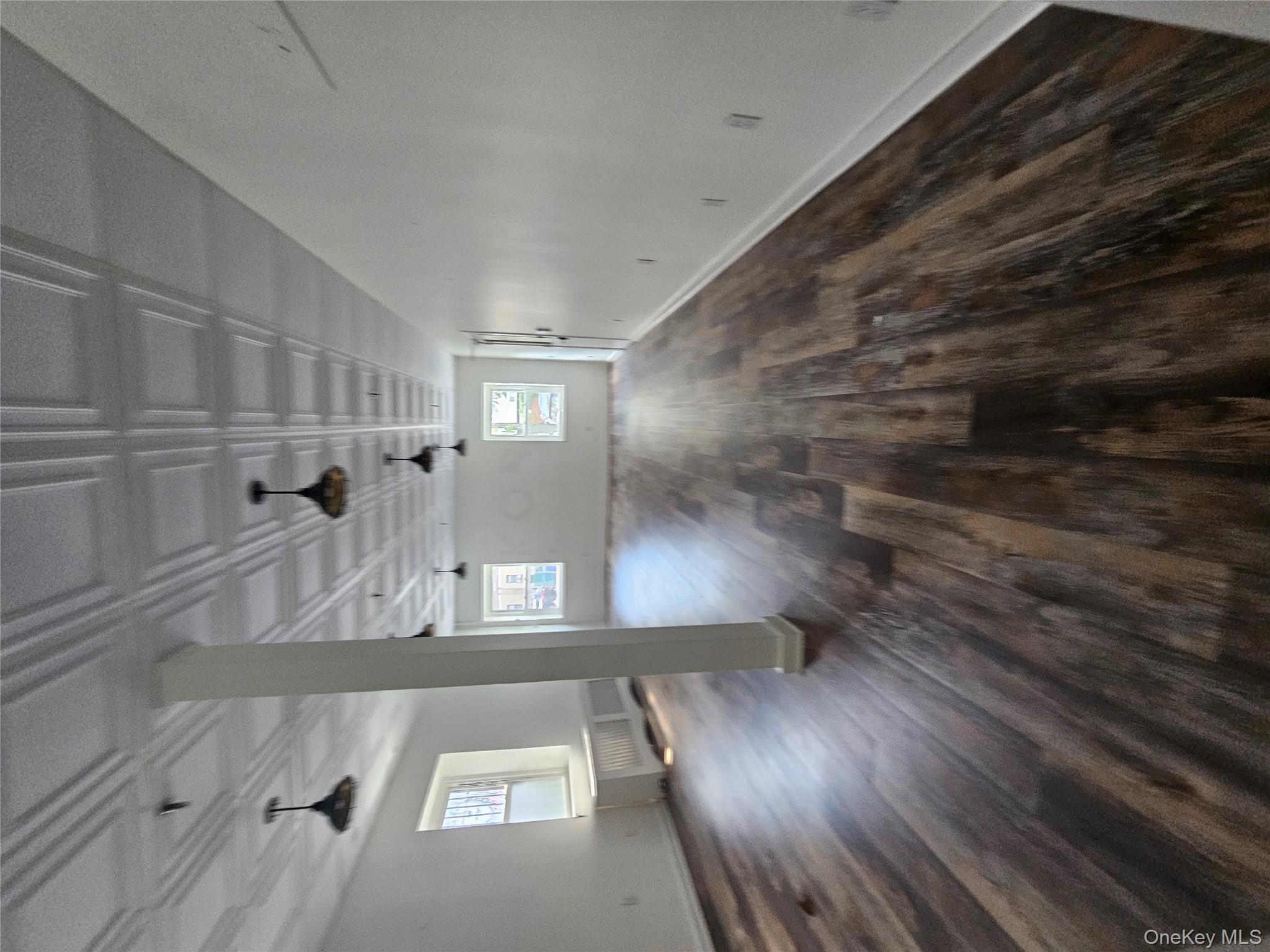 Basement with dark wood finished floors and radiator