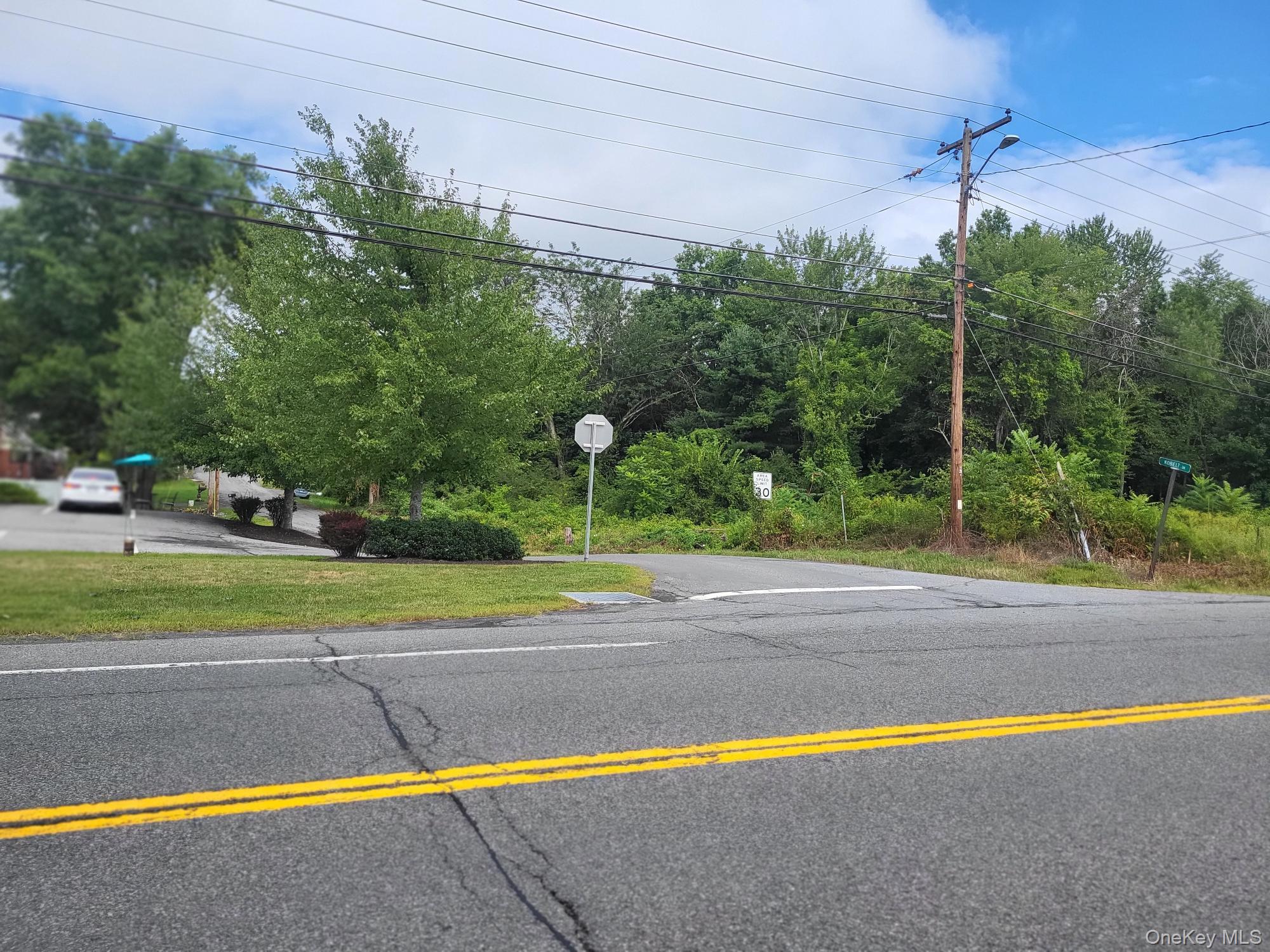 View of asphalt road with traffic signs
