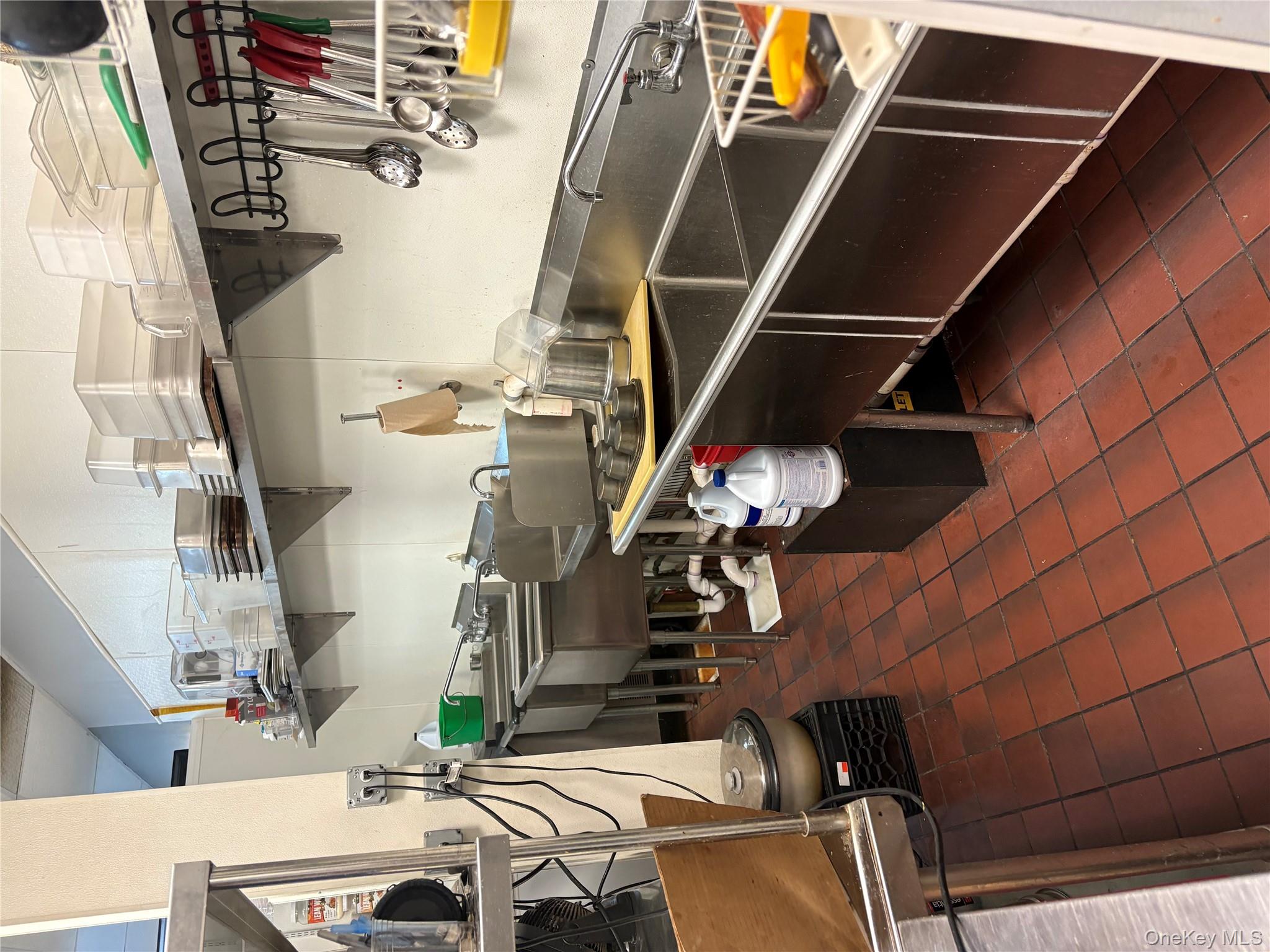 Kitchen featuring dark tile patterned floors