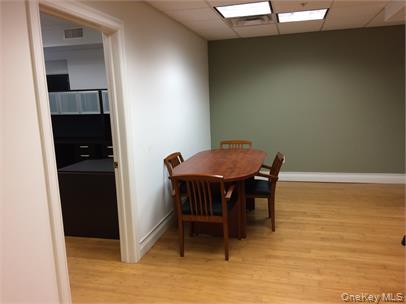 Dining room featuring a drop ceiling and light wood finished floors