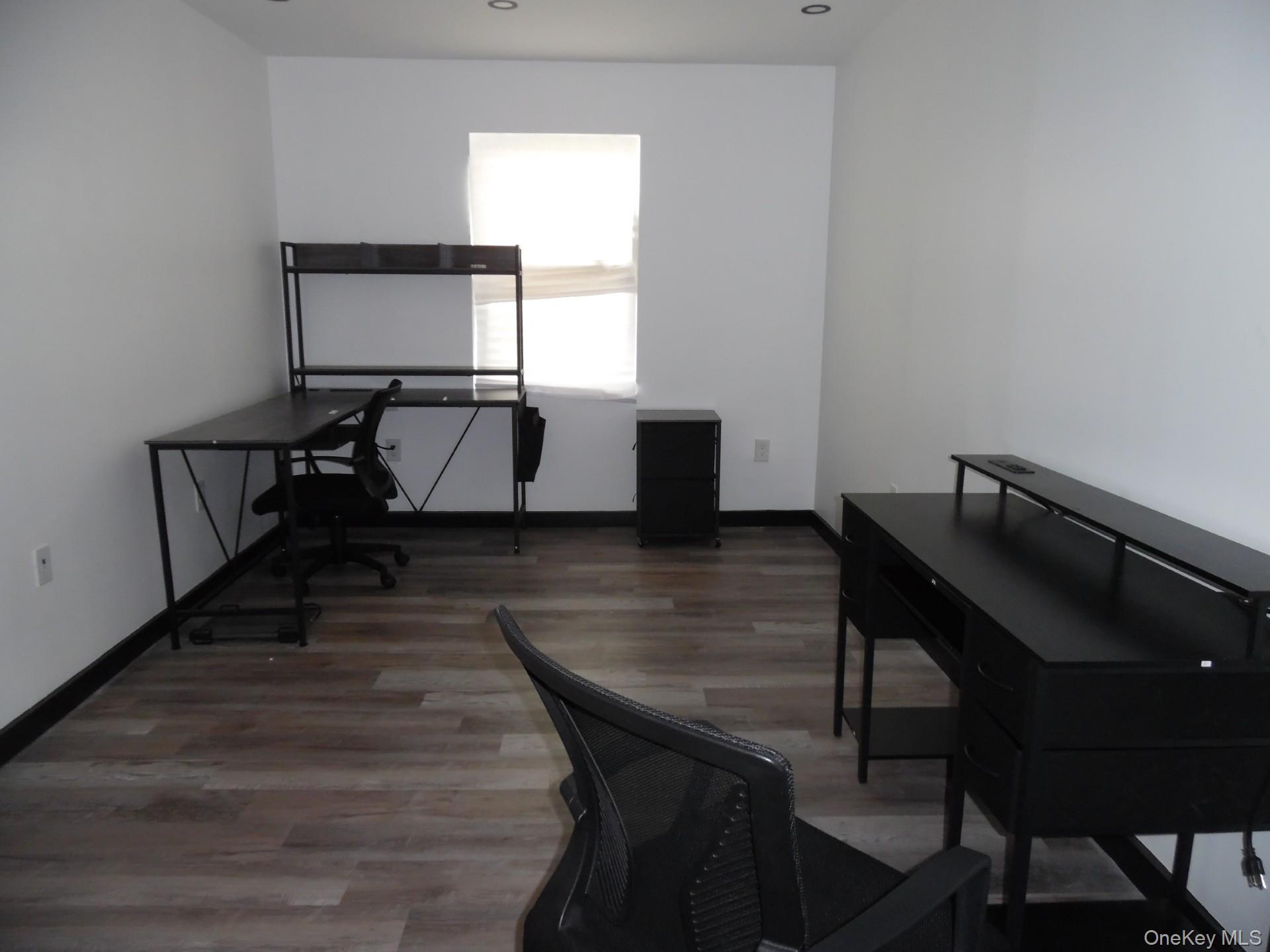 Home office featuring dark wood-style flooring
