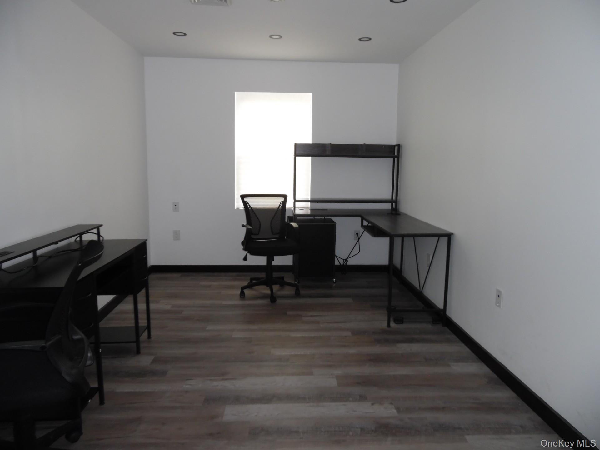 Office area with light wood finished floors and baseboards