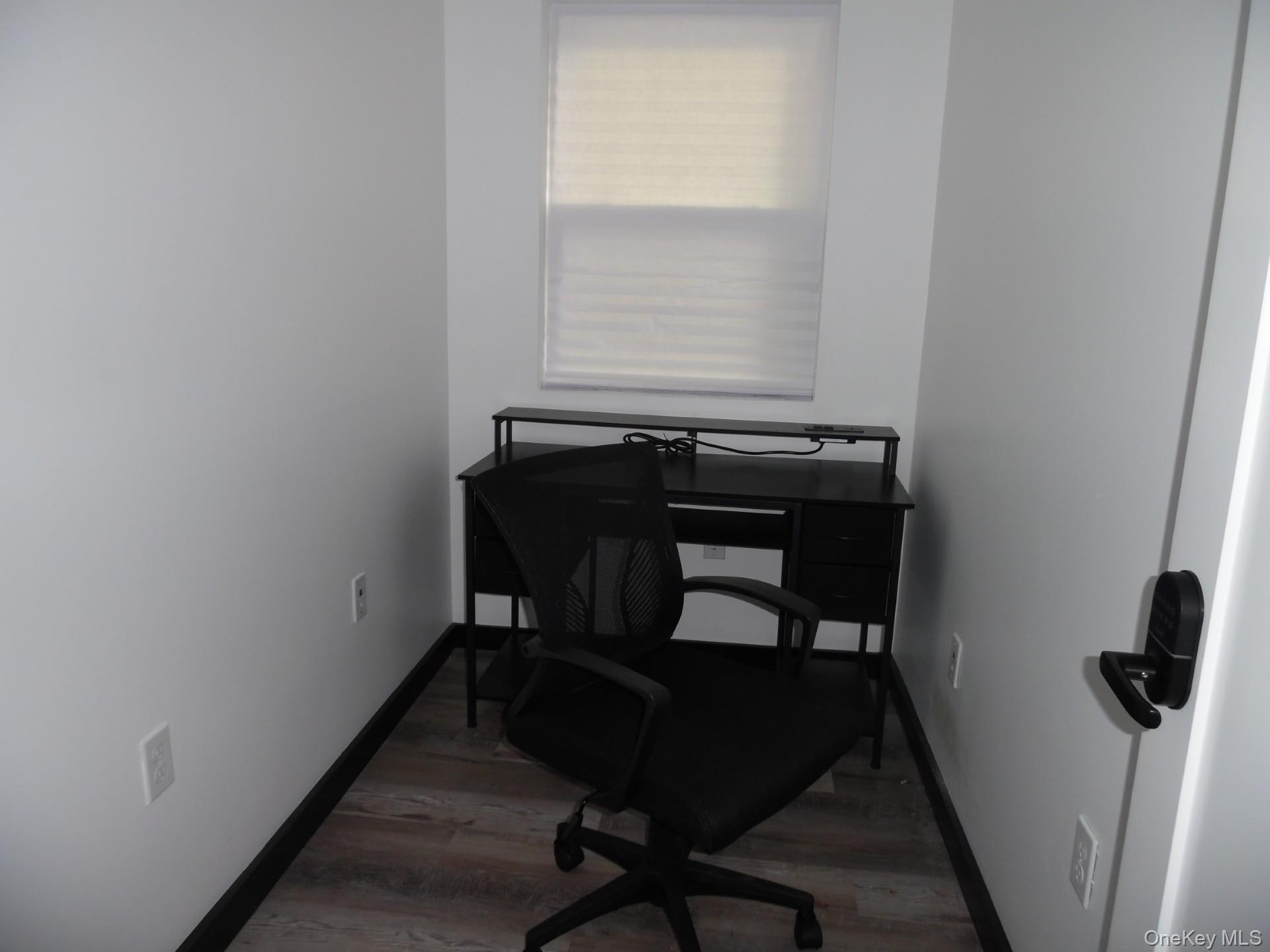 Office area with light wood-style floors